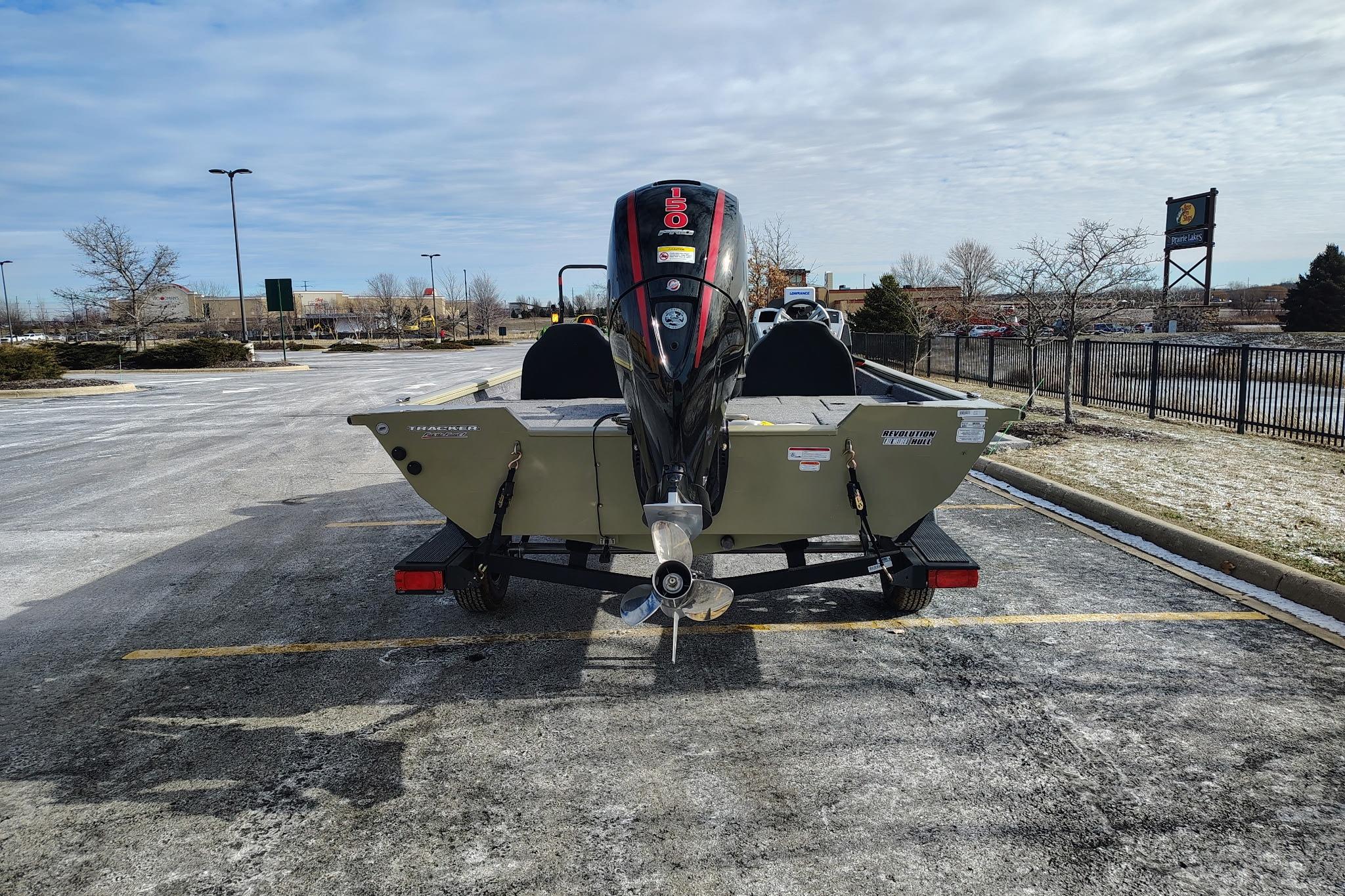 2026 Tracker Pro Team 195 boat on trailer in parking lot, rear view.