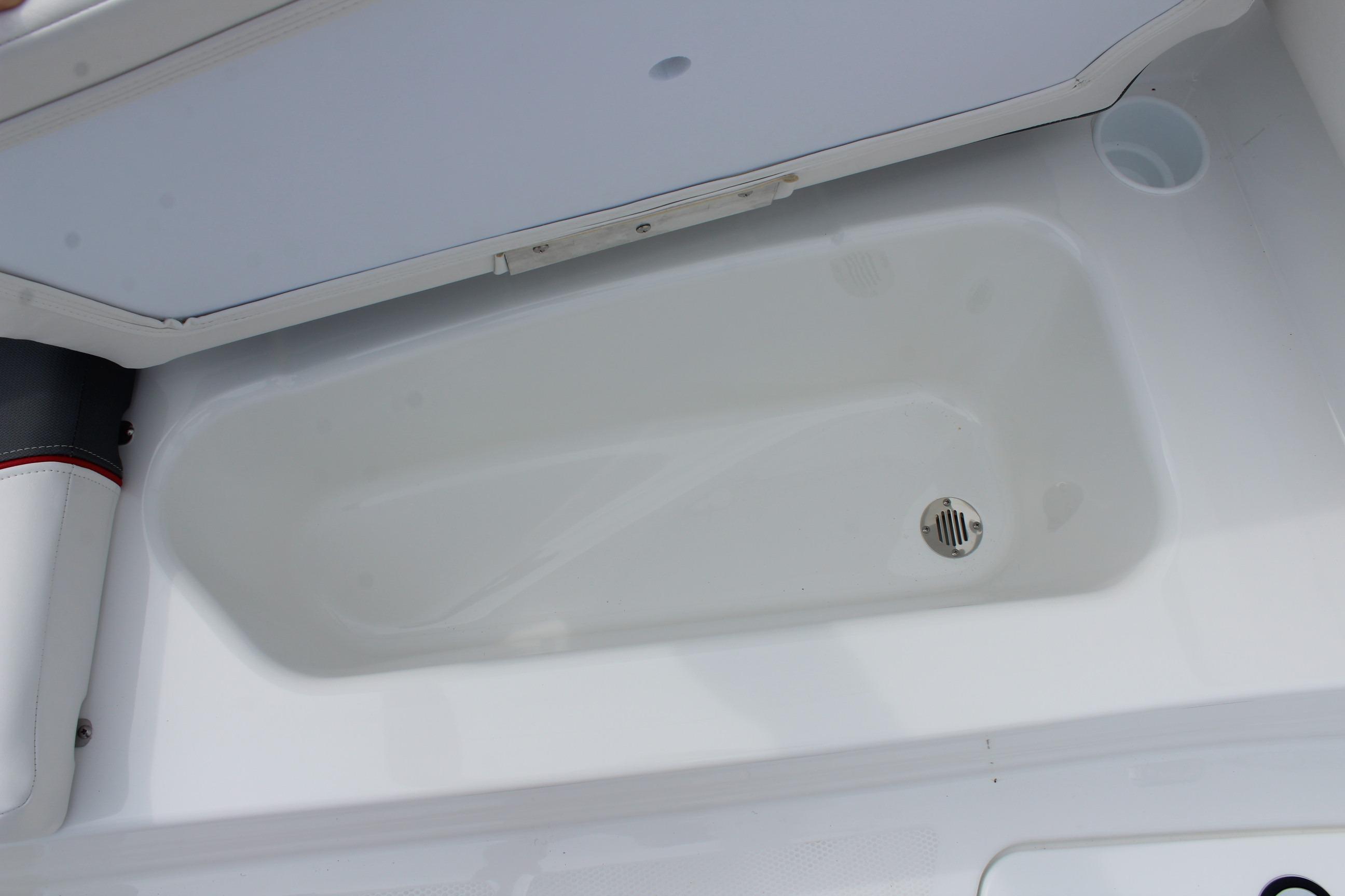 2026 Tahoe T16 boat storage compartment with drain, featuring white interior design.