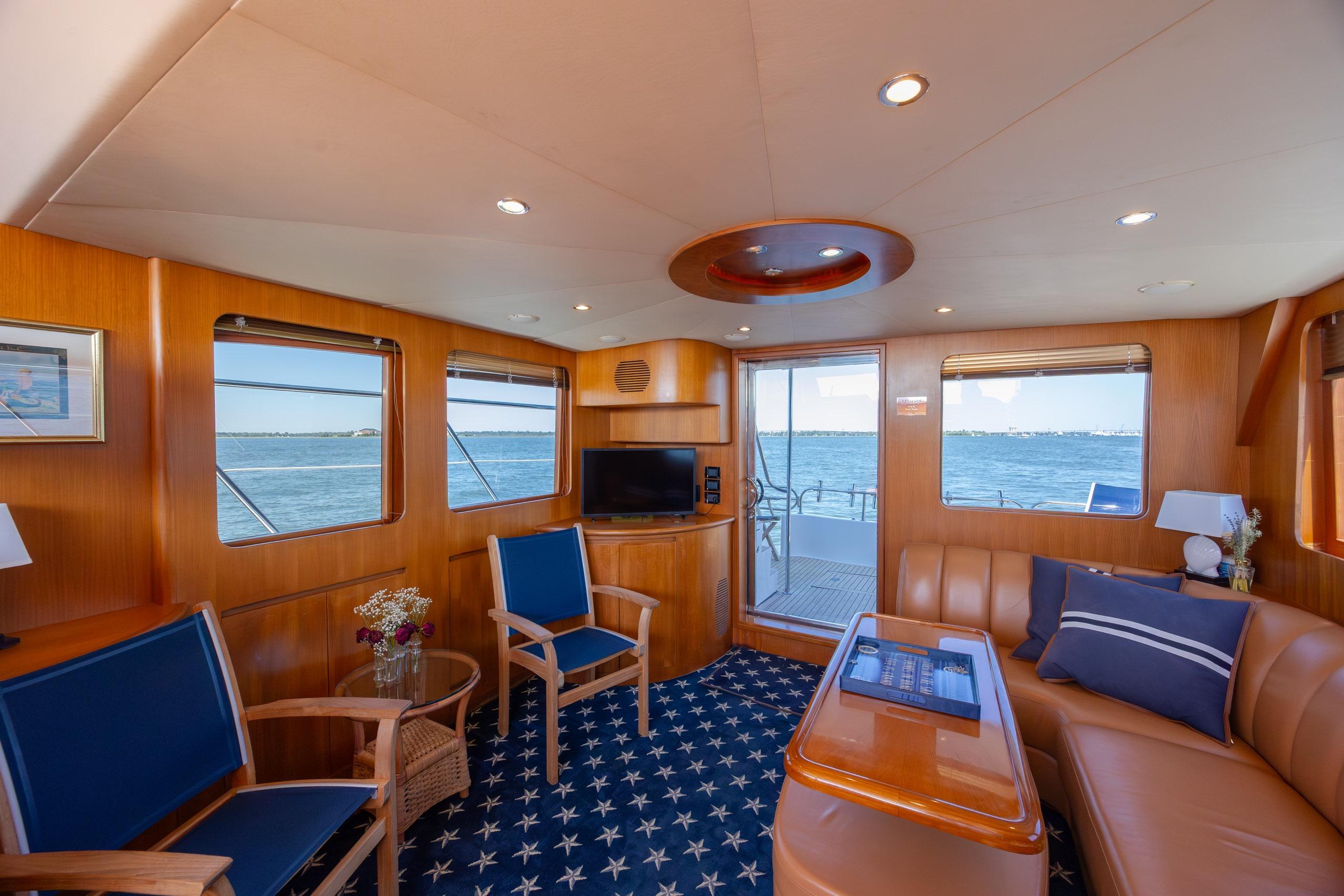 Luxurious interior of 2005 Ocean Alexander 52 Sedan yacht with ocean view and elegant furnishings.