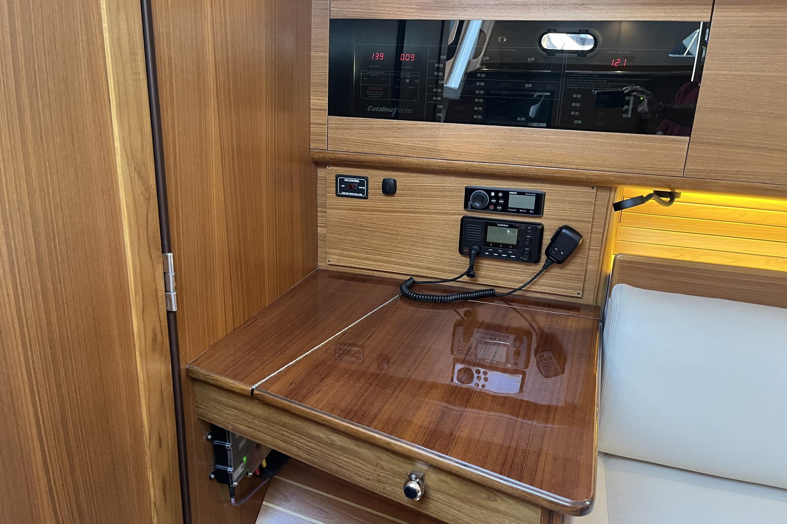 Navigation station in 2026 Catalina 386 yacht with wood finish and communication equipment.