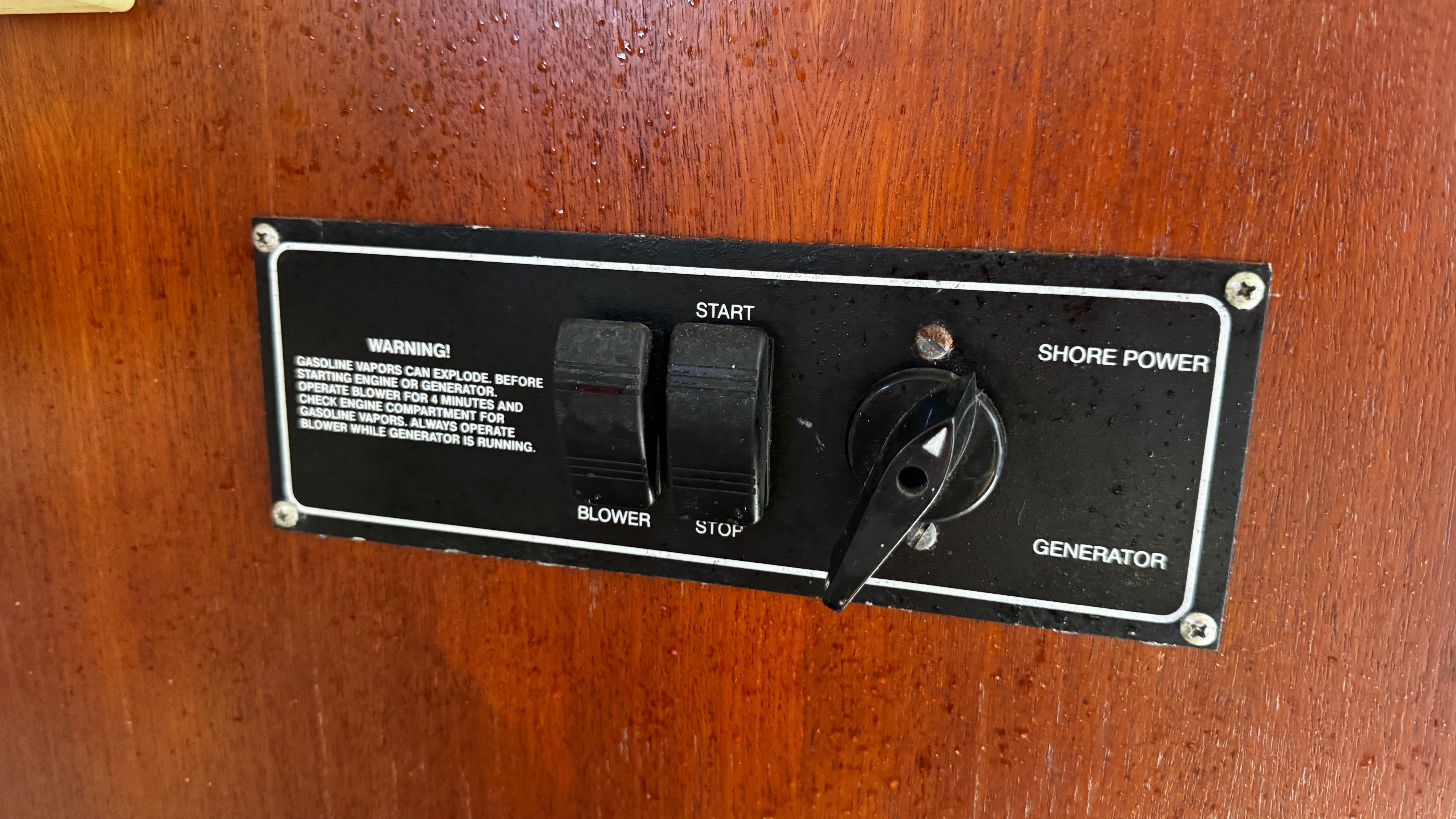 Control panel with start and stop switches, and generator and shore power options.