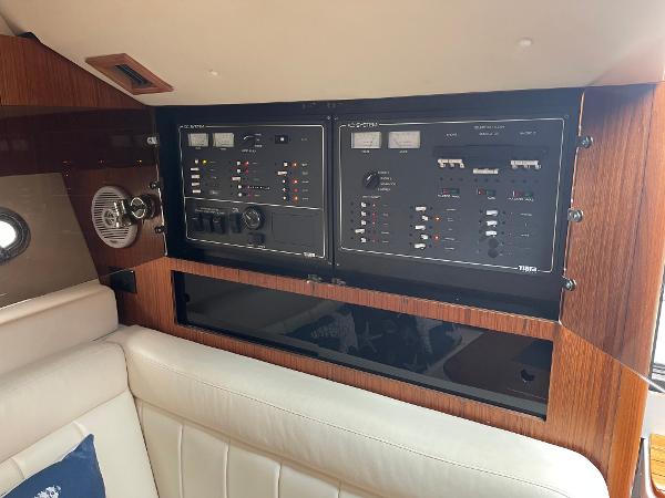 2003 Tiara Yachts 3500 Open interior control panel with wood finish and seating.