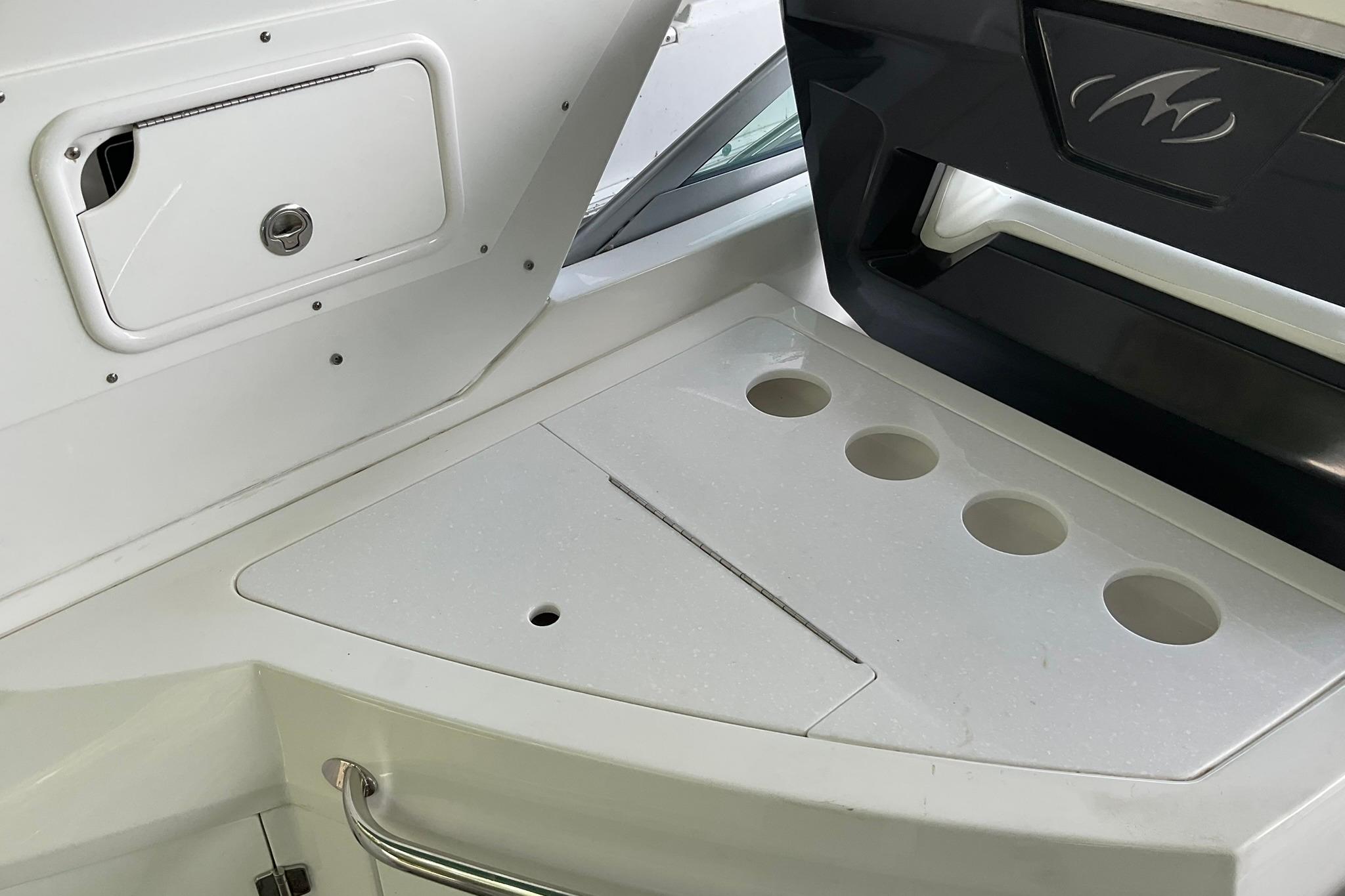 2019 Monterey 335 Sport Yacht interior with cup holders and storage compartment.