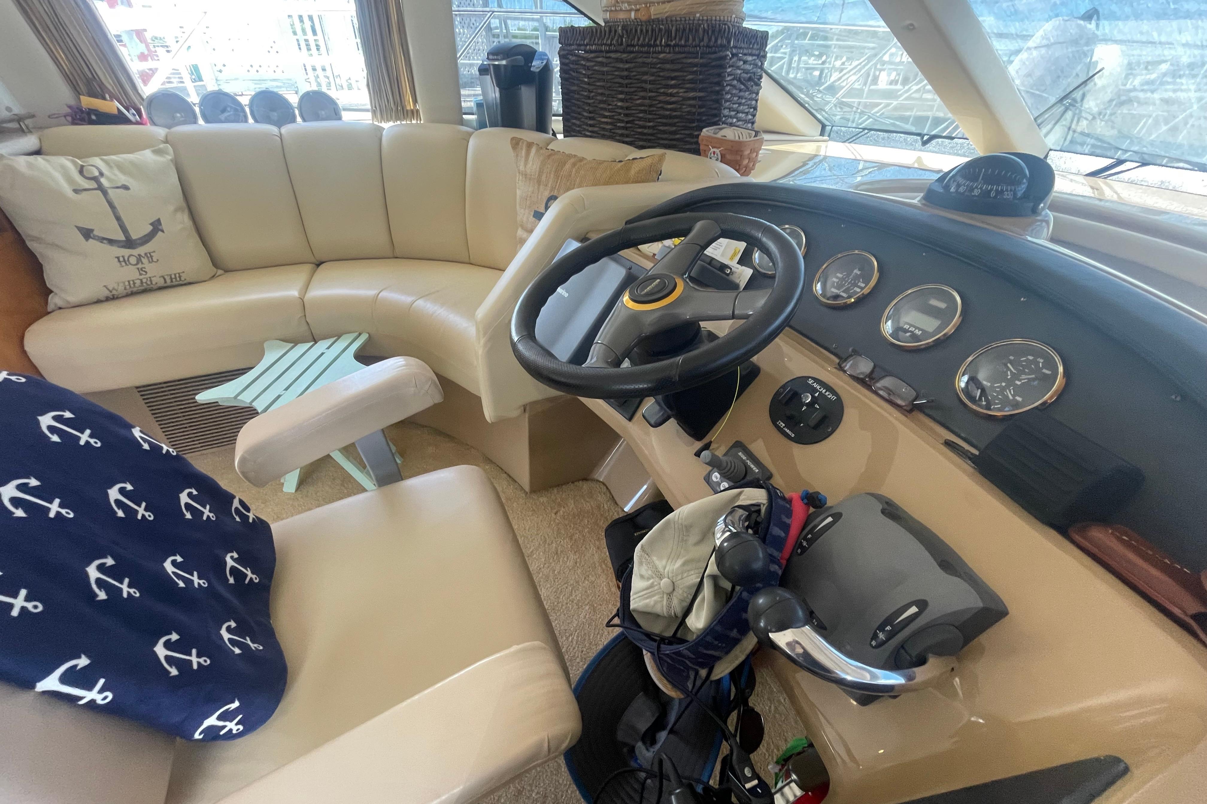 Interior of 2002 Carver 410 Sport Sedan with steering wheel and beige seating.