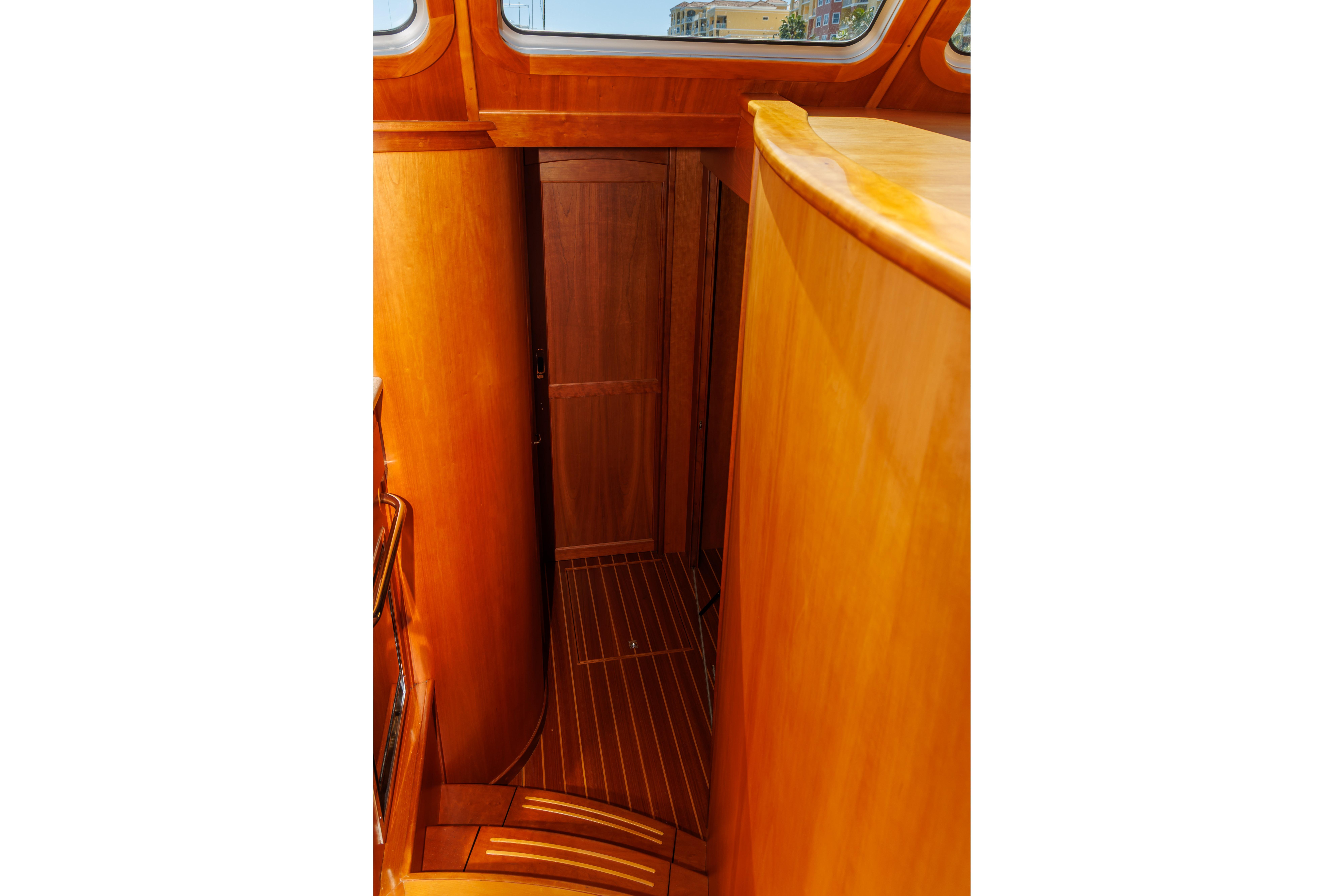 Interior of 2010 Sabre 40 Sedan yacht with wooden finishes and curved staircase.