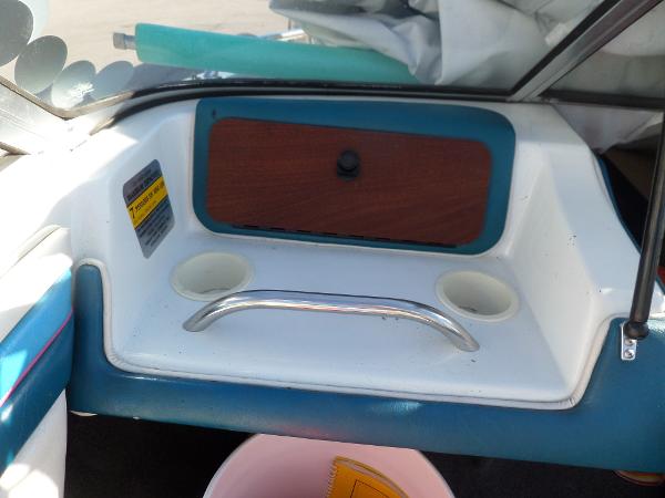 Interior of 1992 Rinker Captiva 170 OB boat with cup holders and storage compartment.