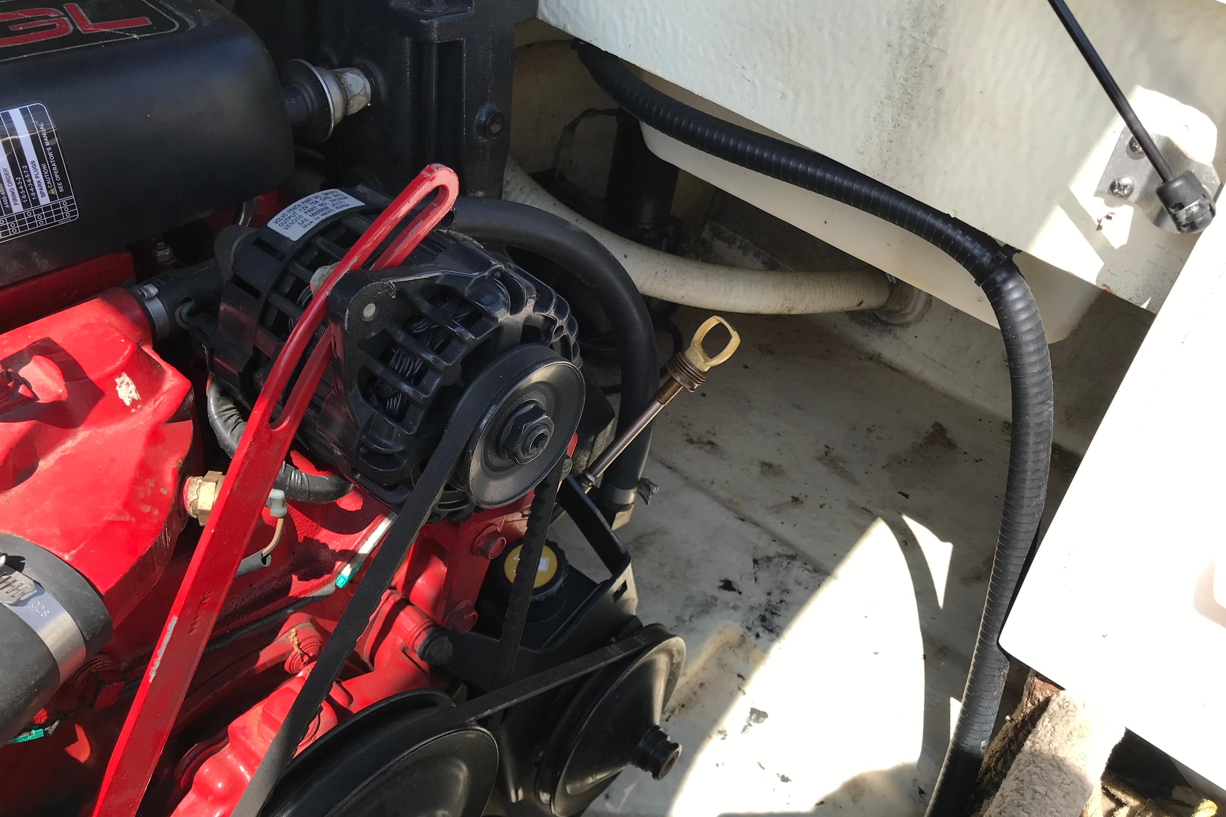 Engine compartment of a 2005 Four Winns 180 Horizon FS boat, featuring a red engine and components.