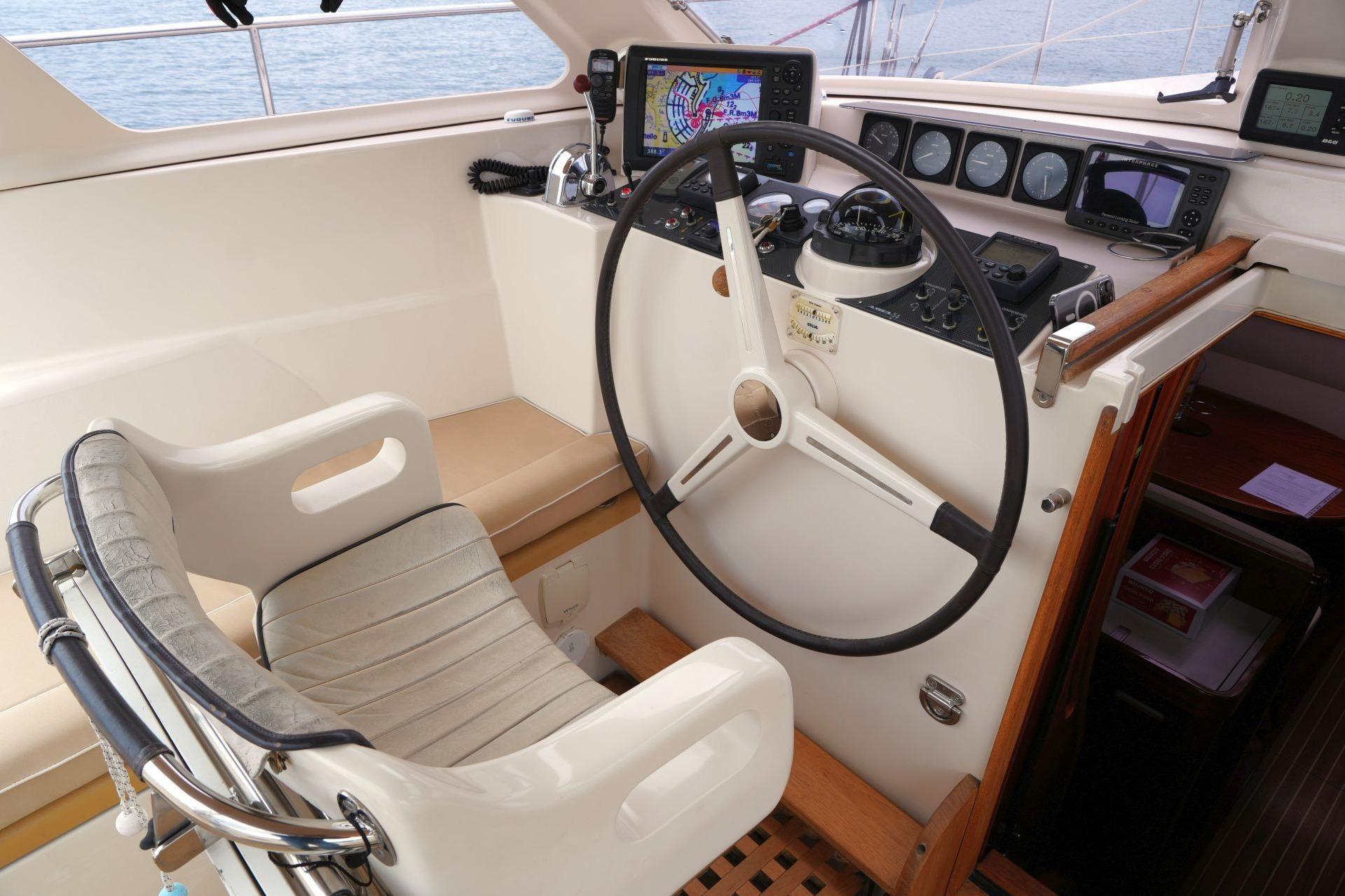 Cockpit of 2010 Amel 54 yacht with navigation instruments and steering wheel.
