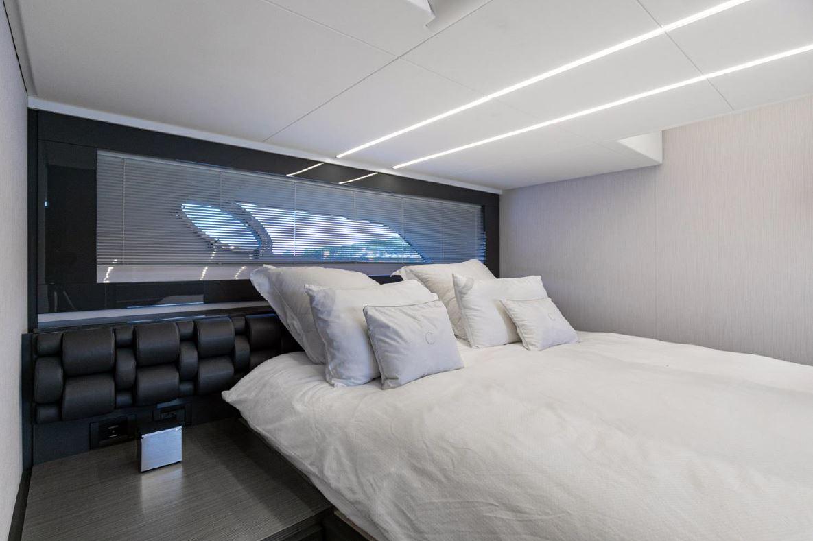 Luxurious bedroom interior of 2018 Pershing 5x yacht with modern design and plush bedding.