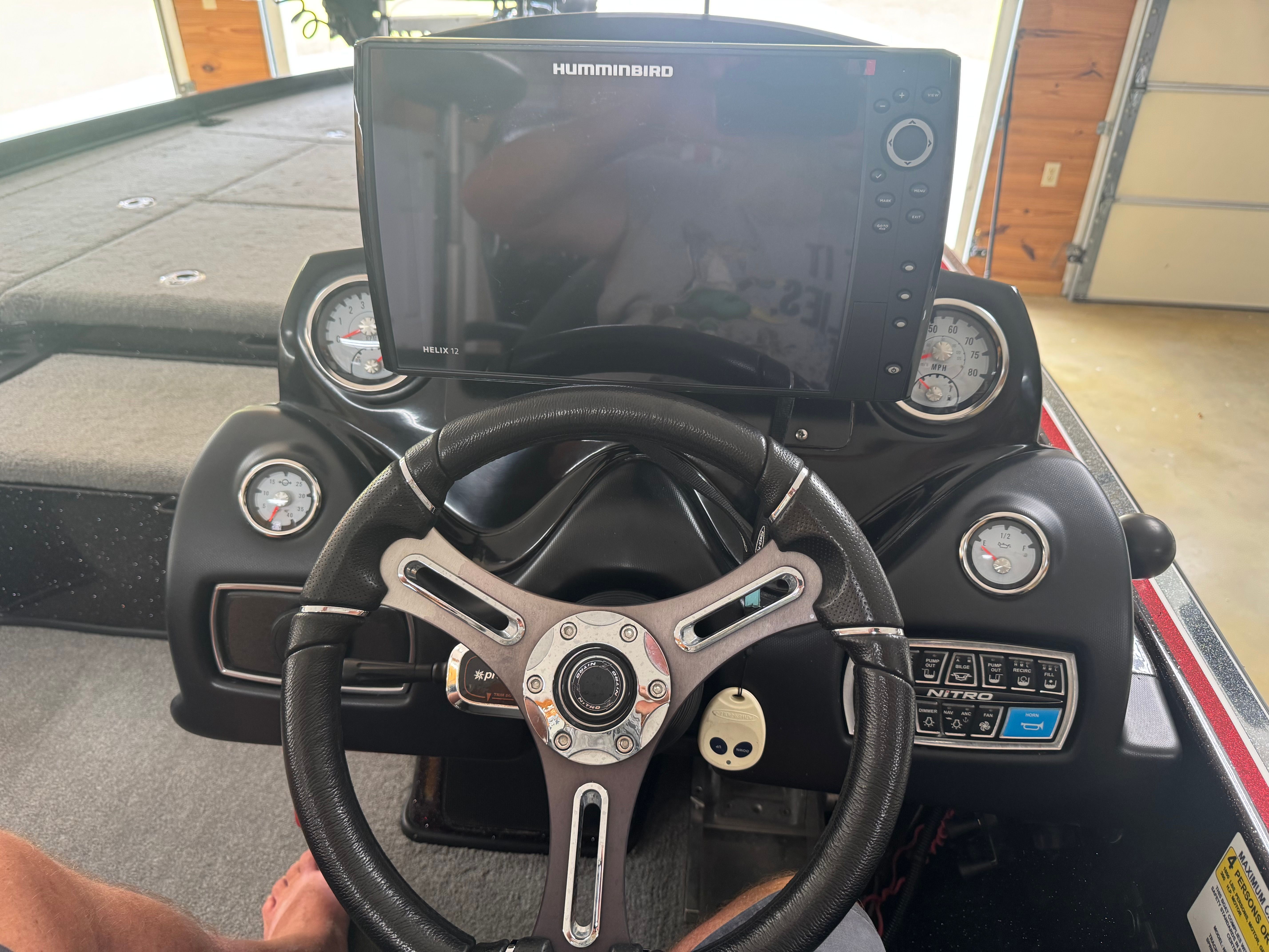 The cockpit of a Nitro Z21 boat with a large screen and multiple gauges.