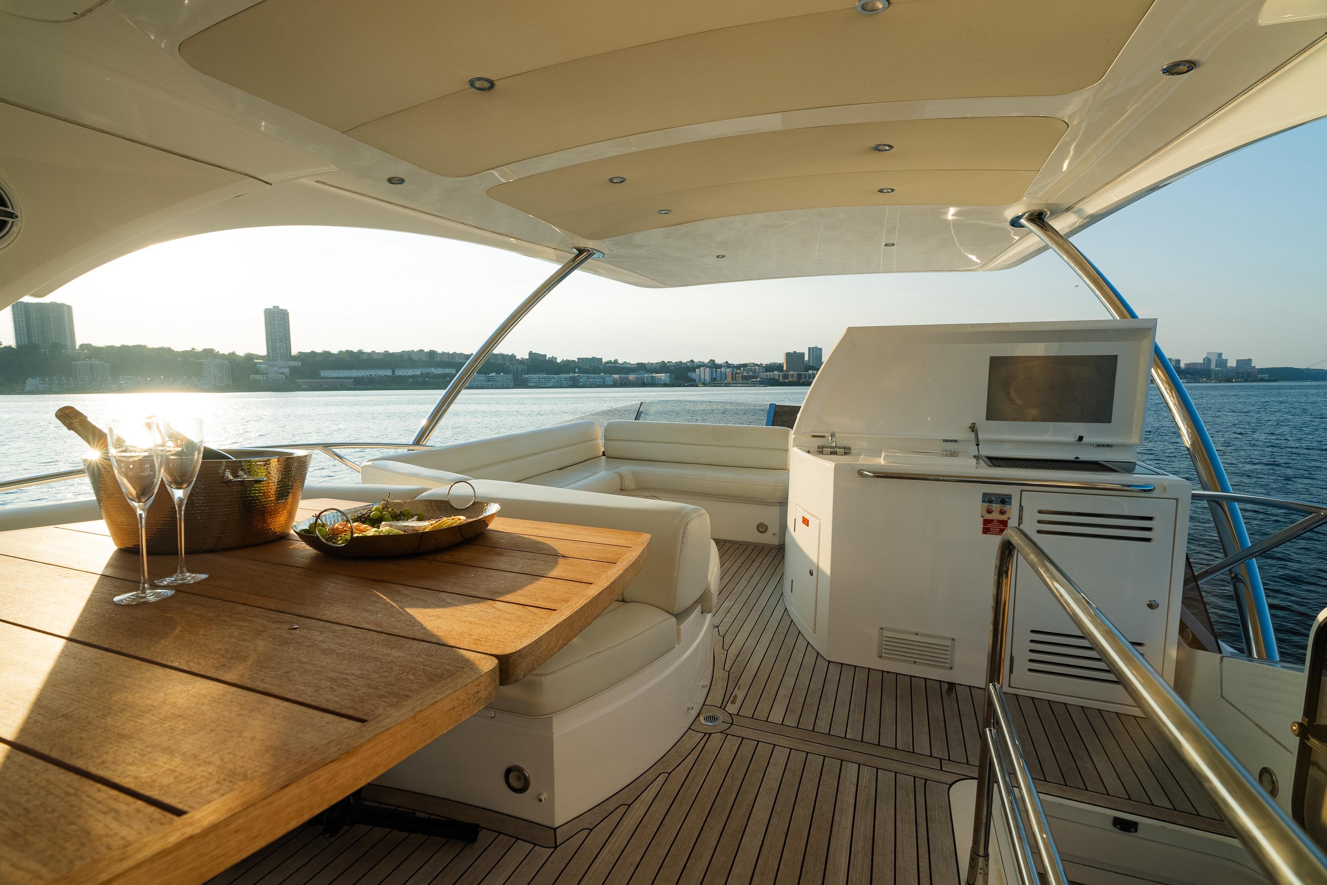 Luxurious 2016 Sunseeker Manhattan 65 yacht interior with dining area and scenic waterfront view.