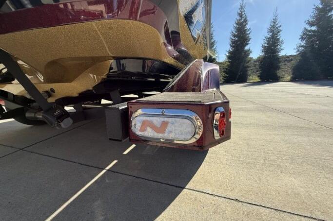 2026 Nitro Z21 XL Pro boat trailer with logo, parked on concrete, sunny day.