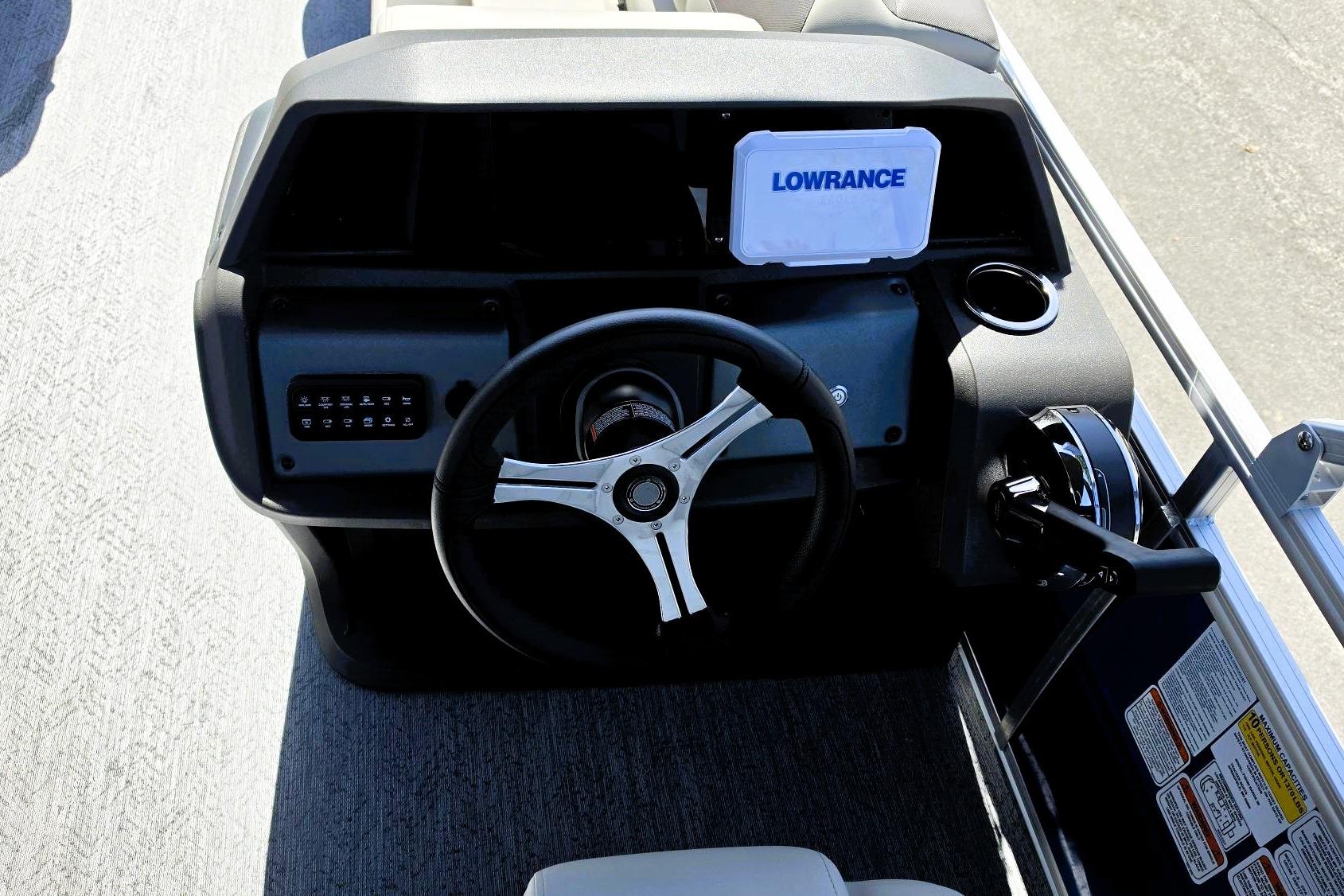 Steering console of 2026 Sun Tracker Fishin' Barge 20 DLX with Lowrance display.
