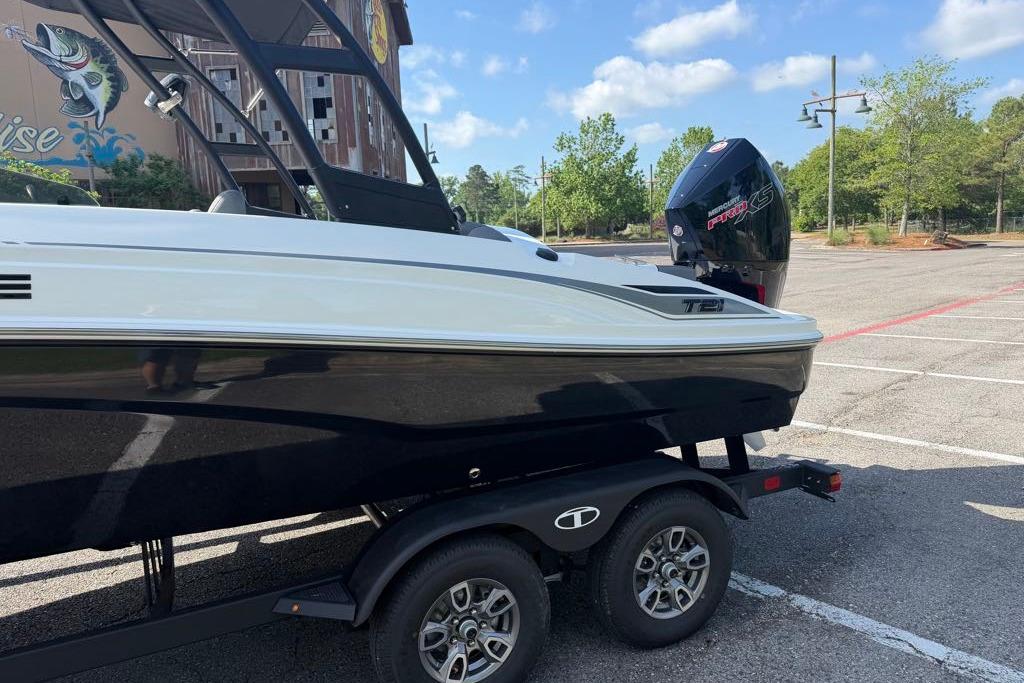 2026 Tahoe T21 boat on trailer in parking lot, featuring sleek design and powerful engine.