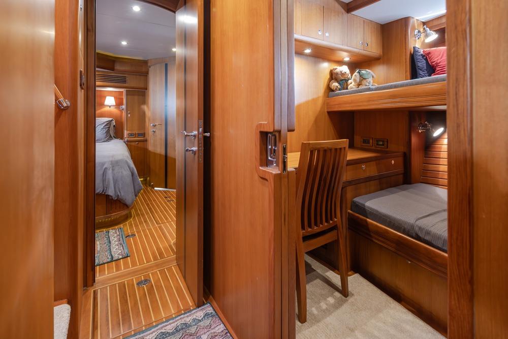 Luxurious 2009 Selene 60 Ocean Trawler interior with cozy wooden cabin and bunk beds.