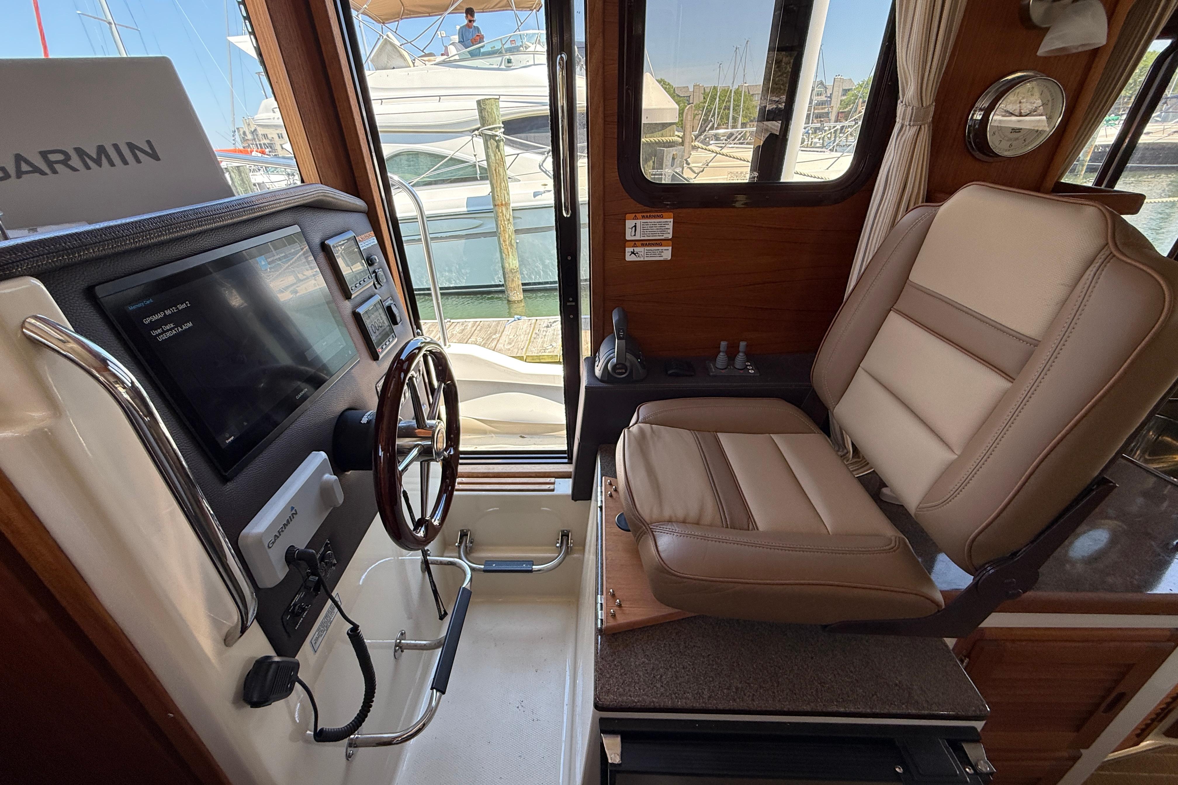 Interior helm of 2020 Ranger Tugs R-31 CB with Garmin navigation system.