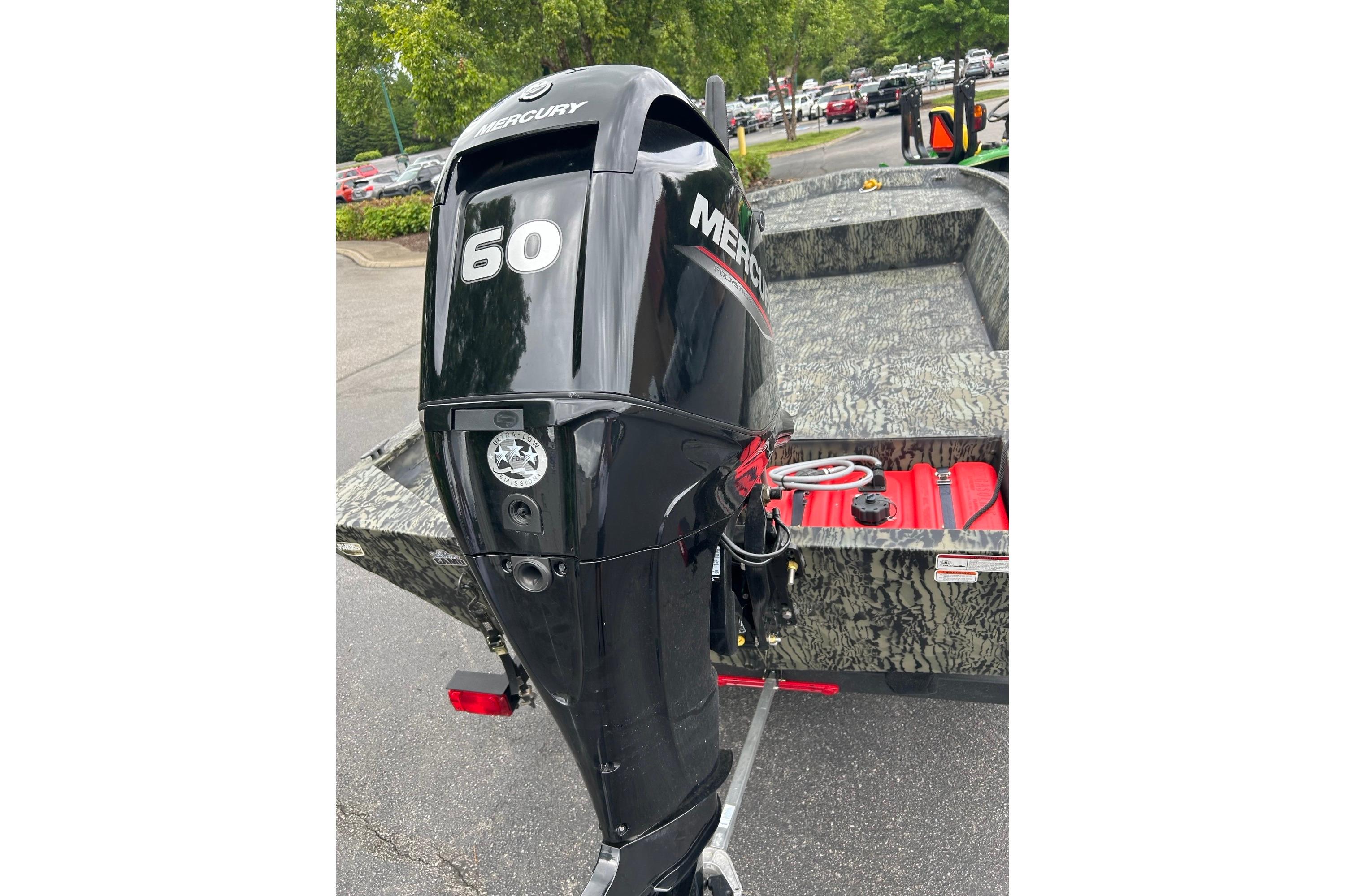 2025 Tracker Grizzly 1860 AWL boat with Mercury 60 outboard motor, parked outdoors.