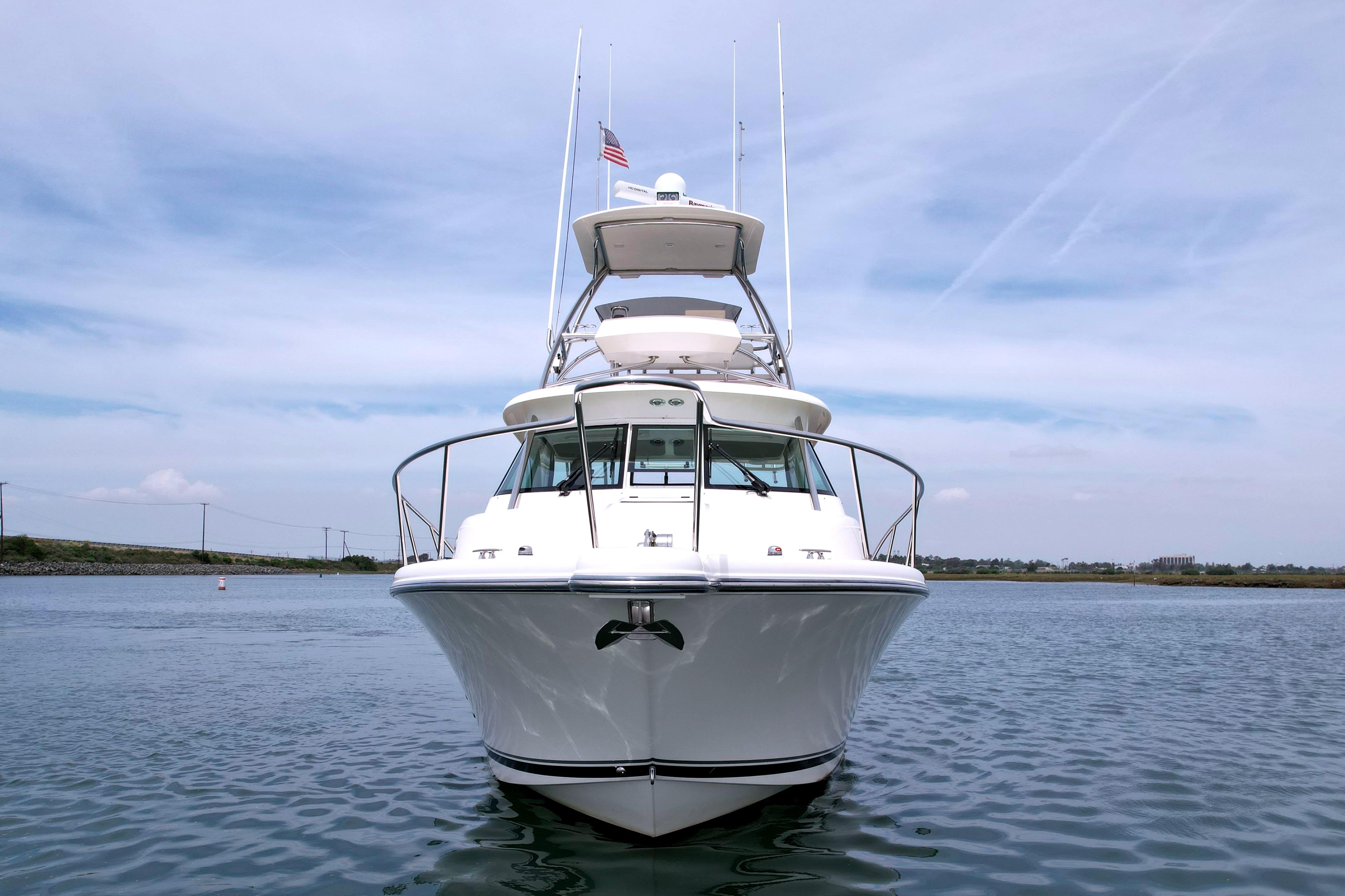2012 Pursuit OS 345 Offshore boat on calm water, front view with clear sky.