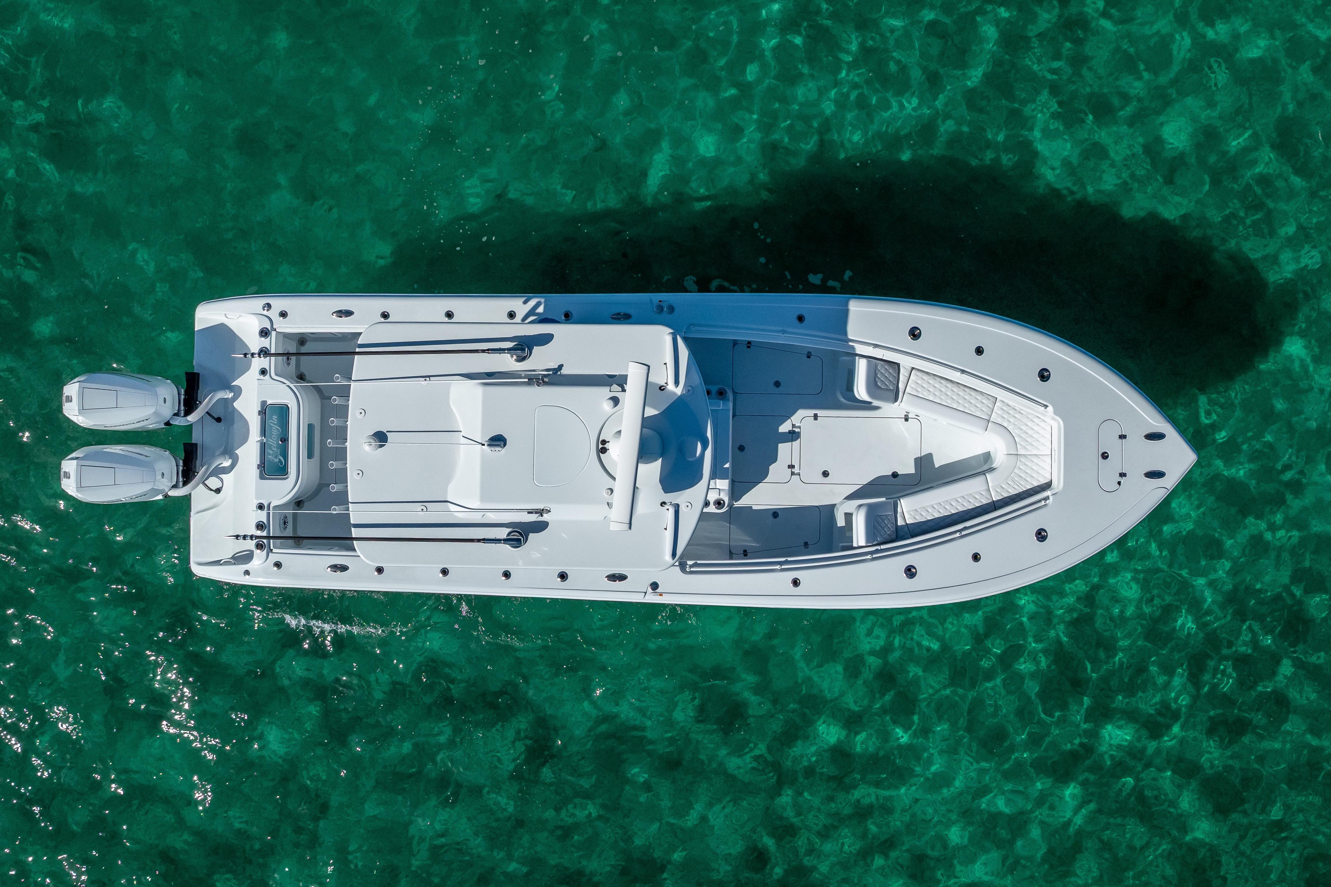 Aerial view of 2026 Yellowfin 32 Offshore boat on clear turquoise water.
