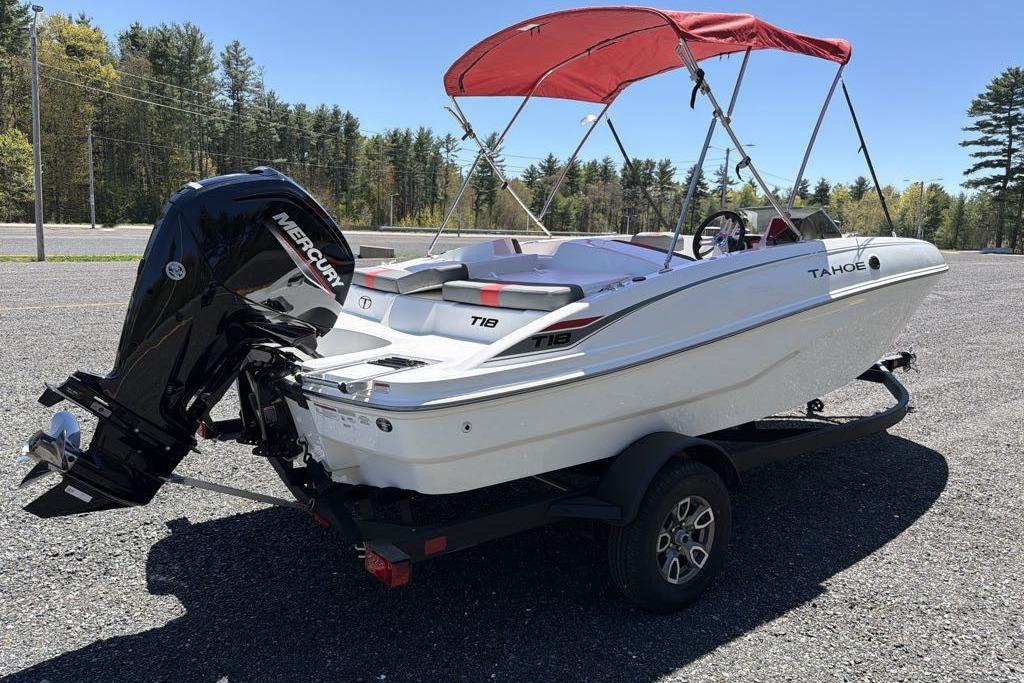 2026 Tahoe T18 boat with red canopy and Mercury outboard motor on trailer.