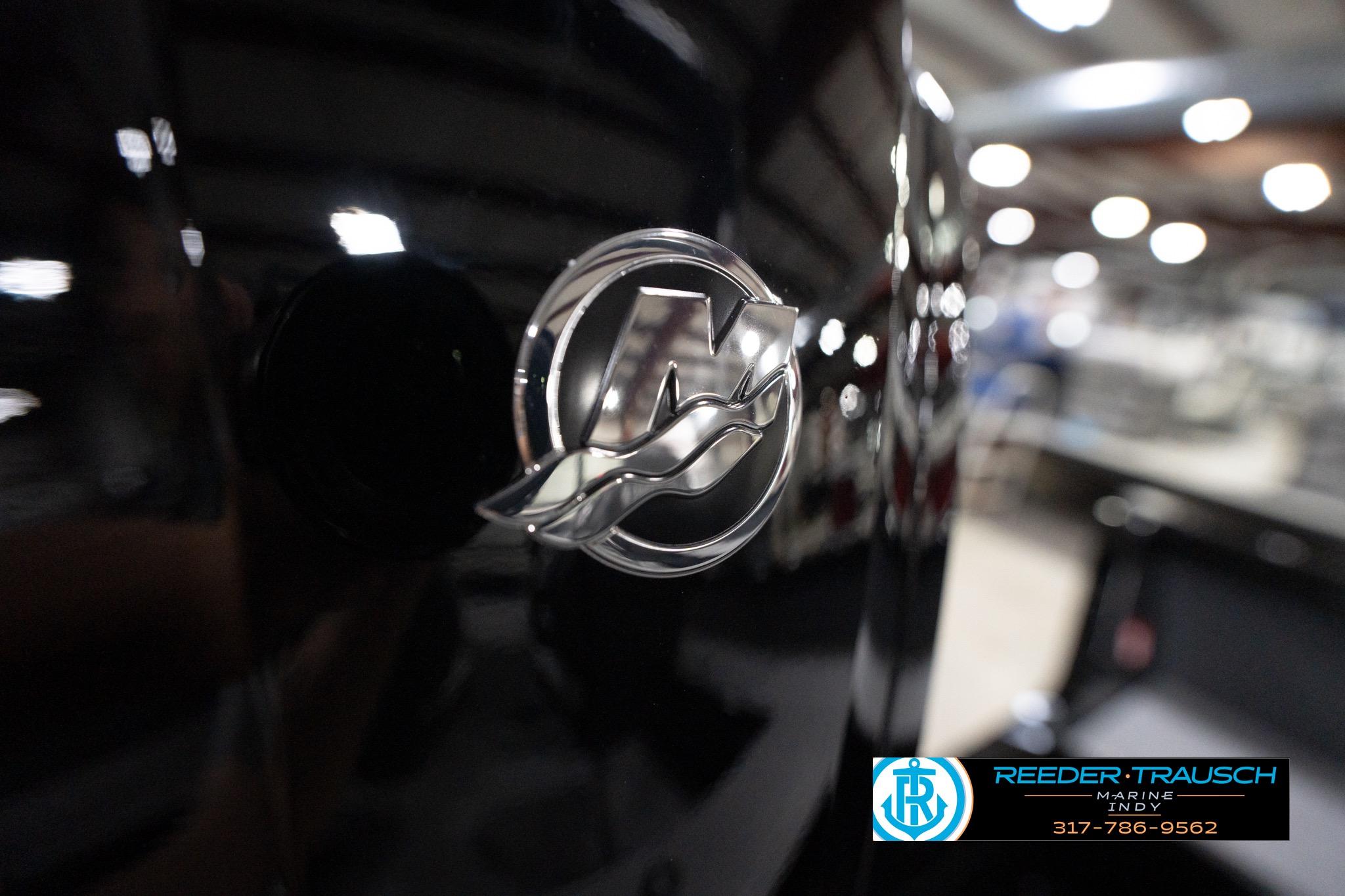 Close-up of 2026 Lund 1800 Explorer Sport logo in a showroom setting.