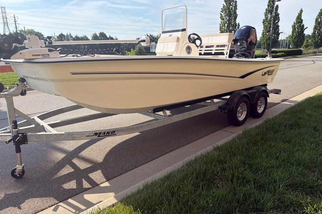 2026 Mako Pro Skiff 19 CC boat on trailer, parked on a sunny street.