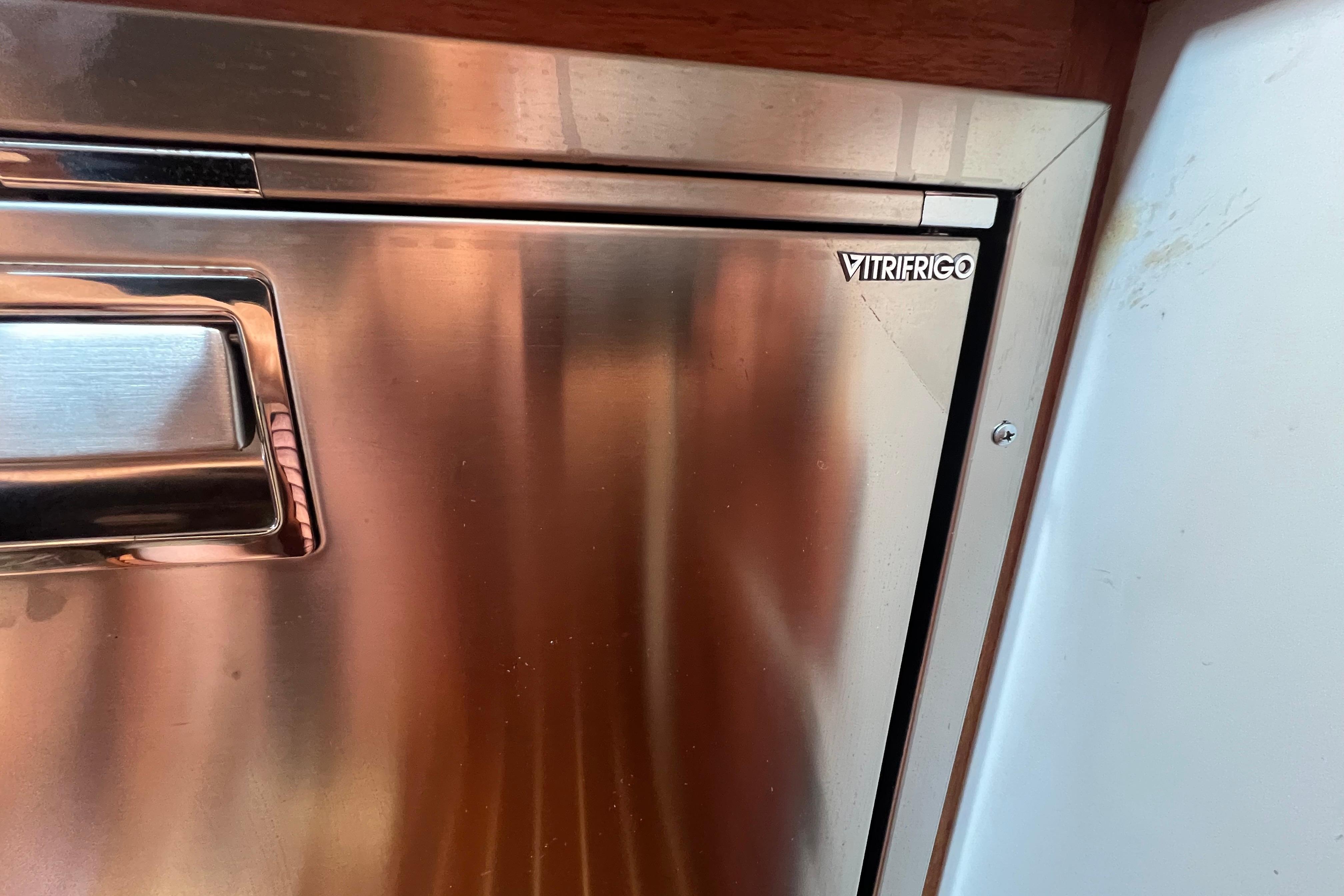 Stainless steel Vitrifrigo refrigerator door on a 1985 Tiara 36 OPEN boat.