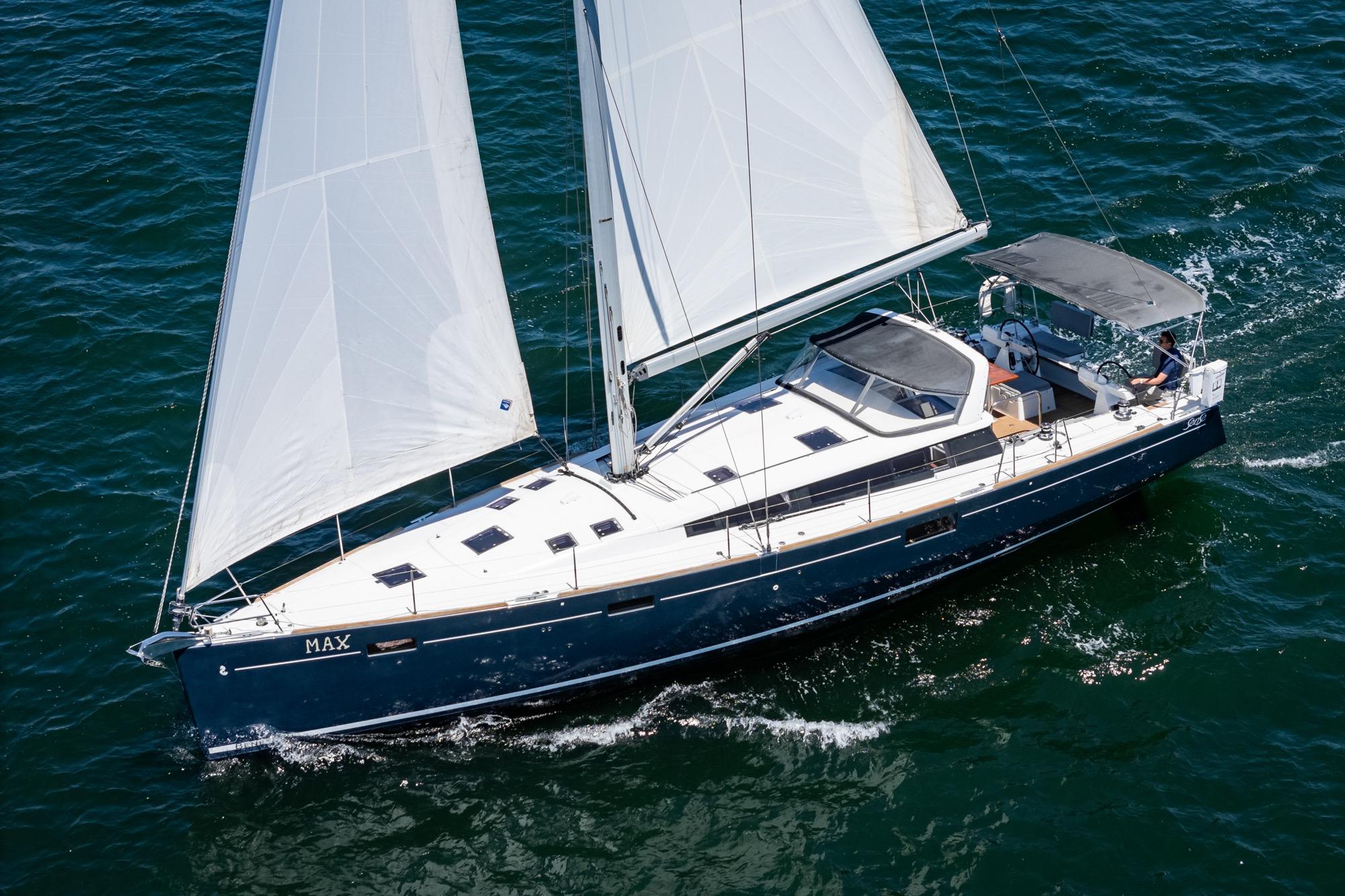 2017 Beneteau Sense 50 sailing yacht on open water, white sails unfurled.