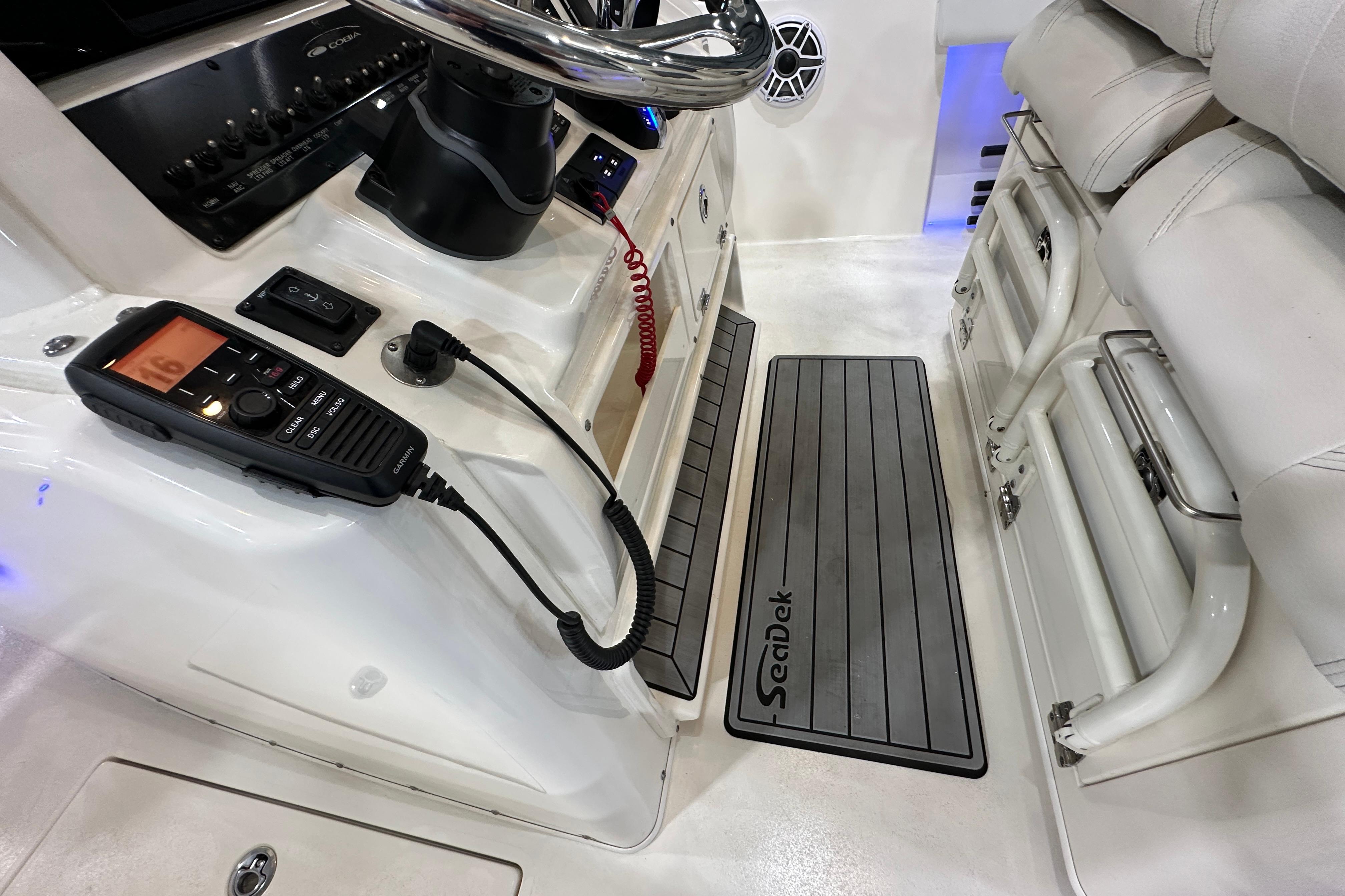 2024 Cobia 301 Center Console interior with radio and SeaDek flooring.