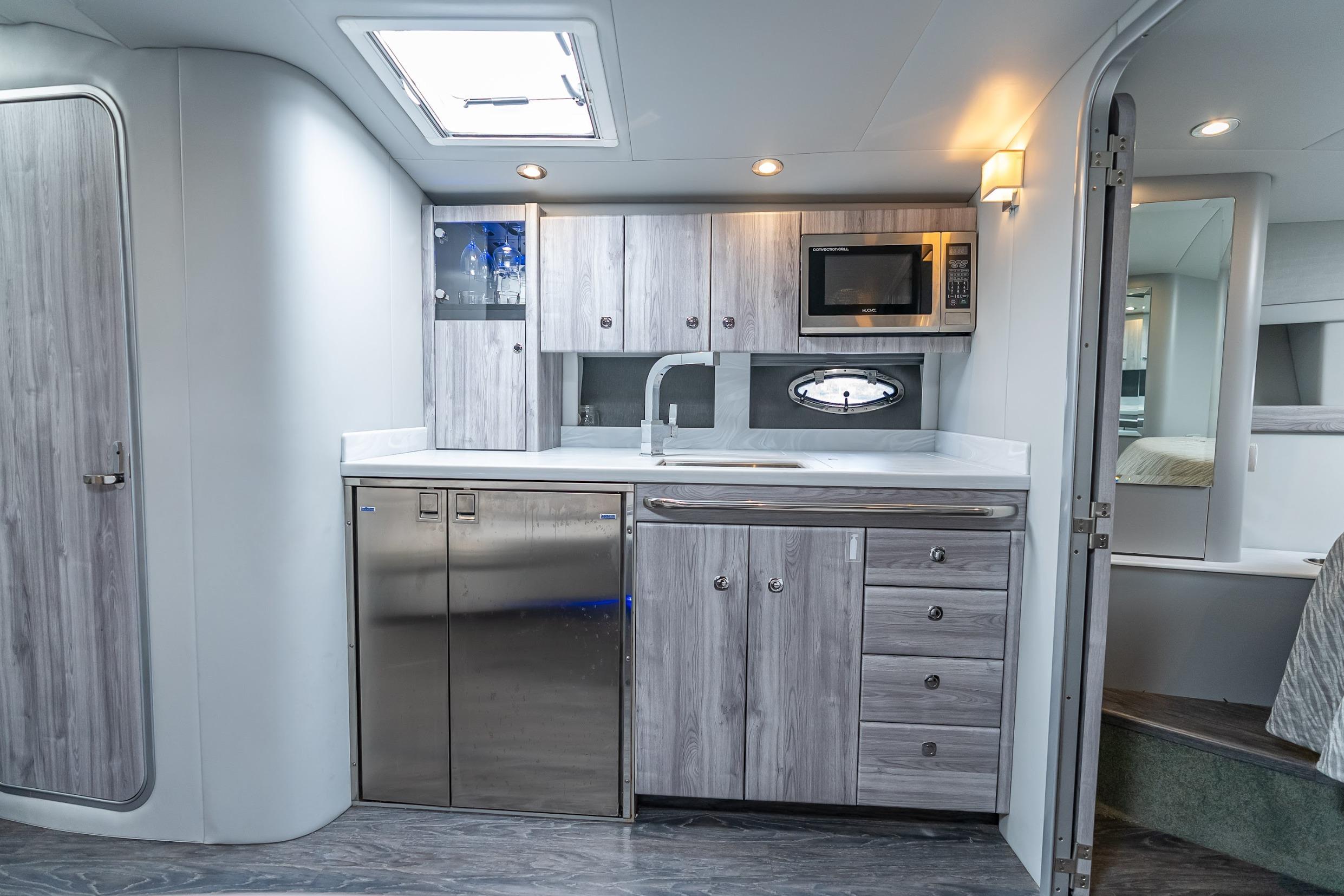 2022 Formula 40 Performance Cruiser interior kitchen with modern appliances and sleek cabinetry.