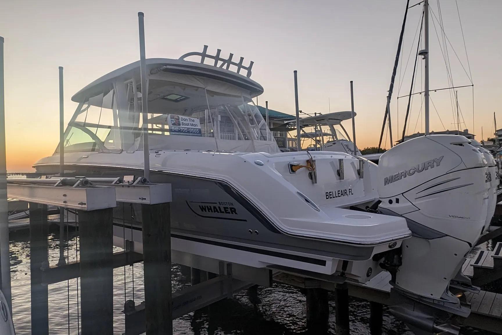 2017 Boston Whaler 320 Vantage boat docked at sunset with Mercury engines.