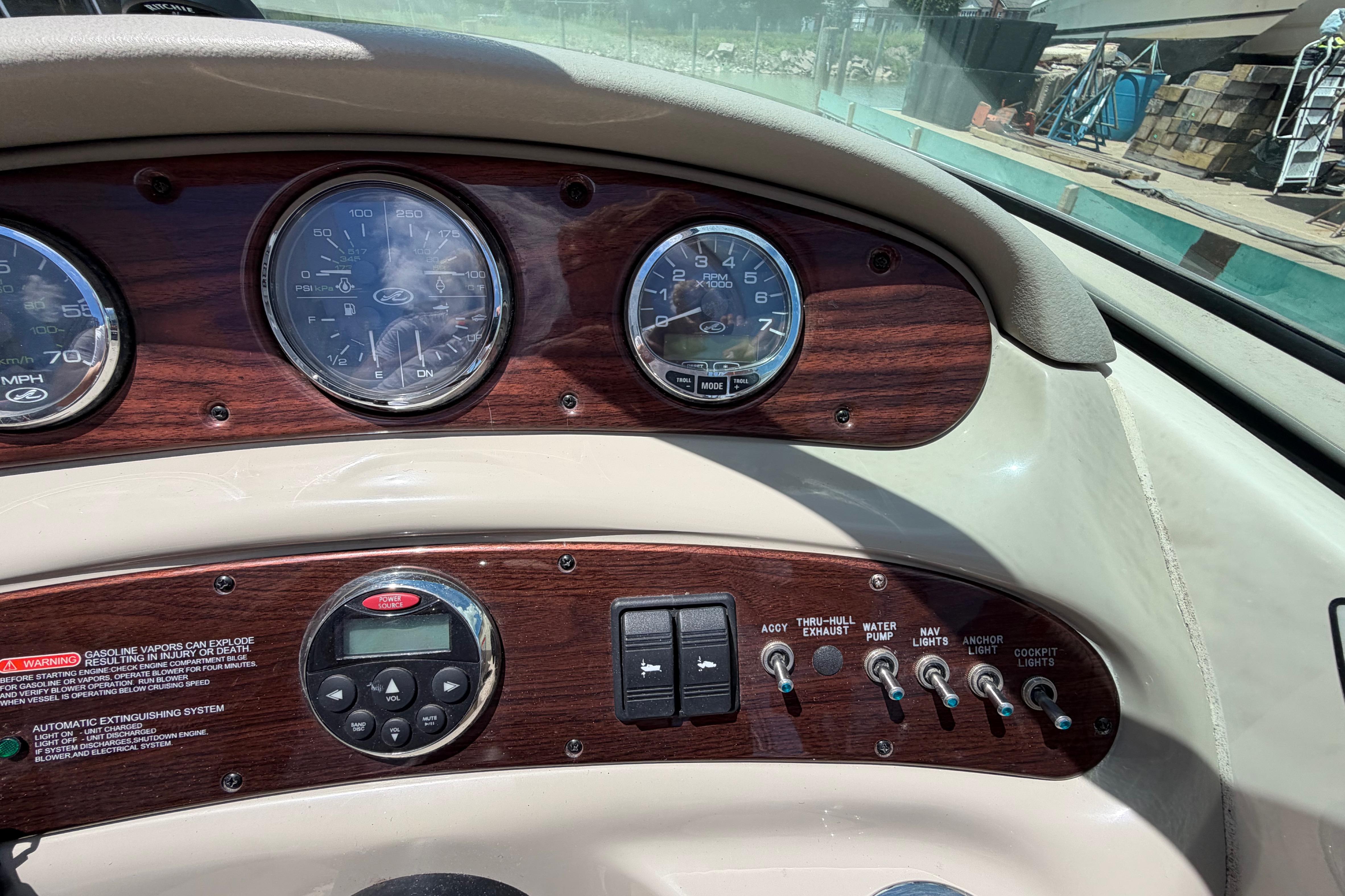 Dashboard of a 2004 Sea Ray 240 Sundeck boat with gauges and controls.