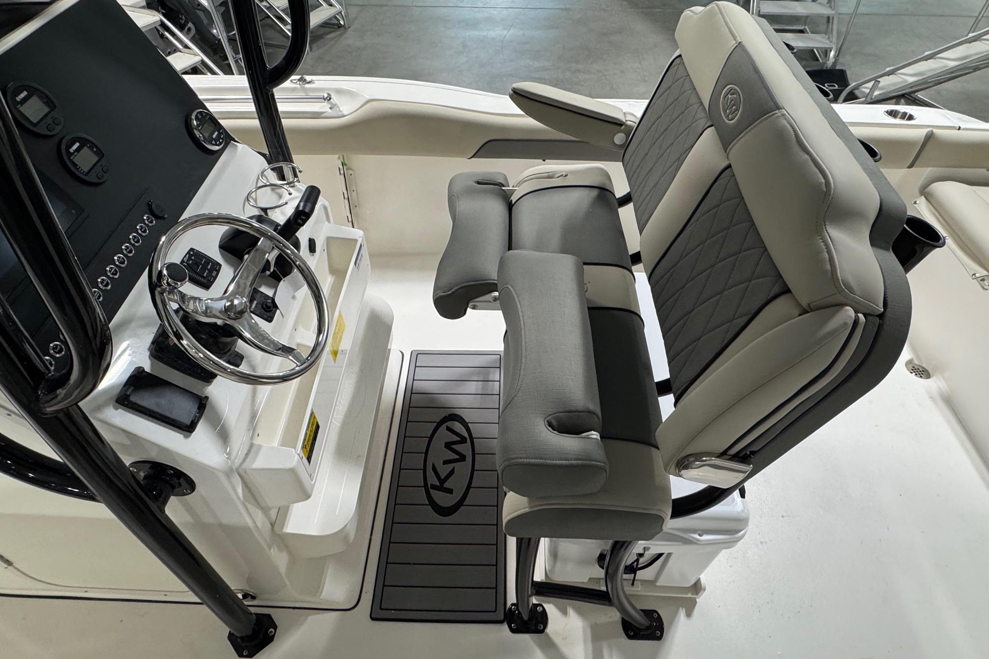 2026 Key West 239 FS boat interior with steering console and cushioned seating.