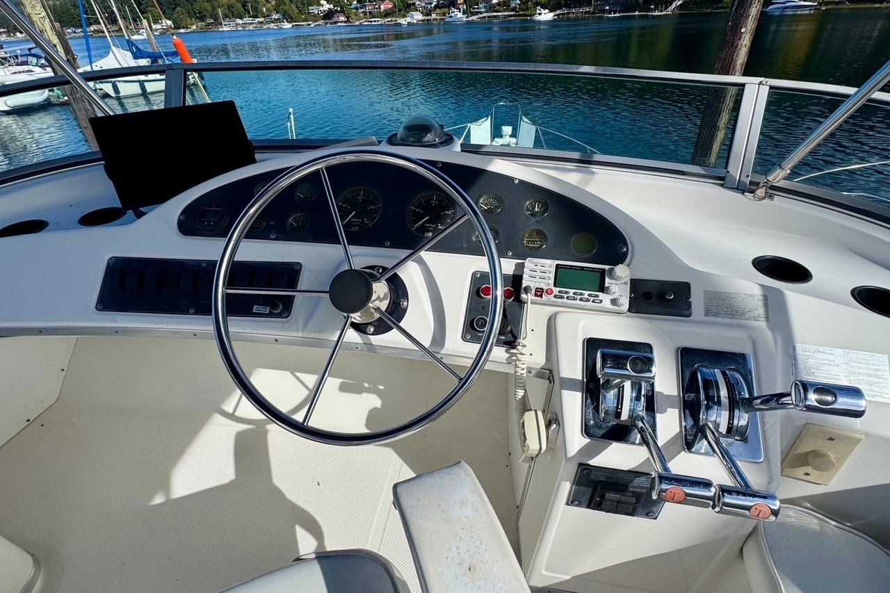 1998 Bayliner 3388 Command Bridge Motoryacht helm with steering wheel and controls.