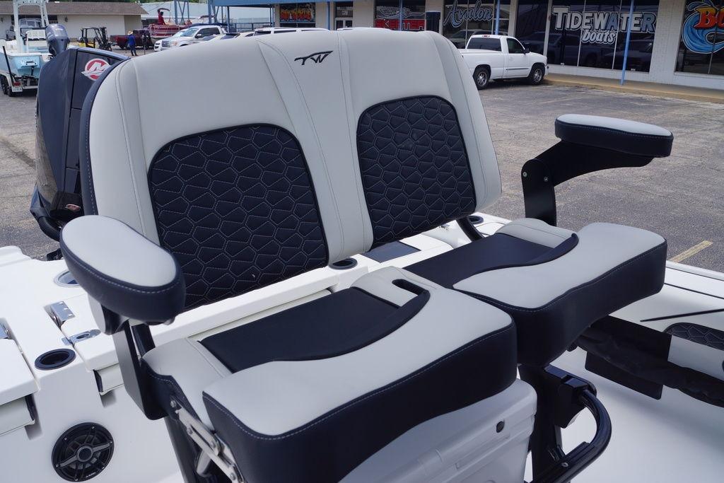 2027 Tidewater 2500 Carolina Bay boat seats with armrests in a showroom.