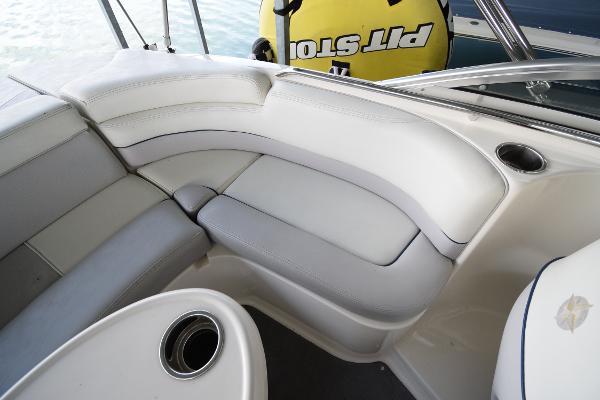 Interior of a 2010 Bryant 255 boat with white upholstered seating.