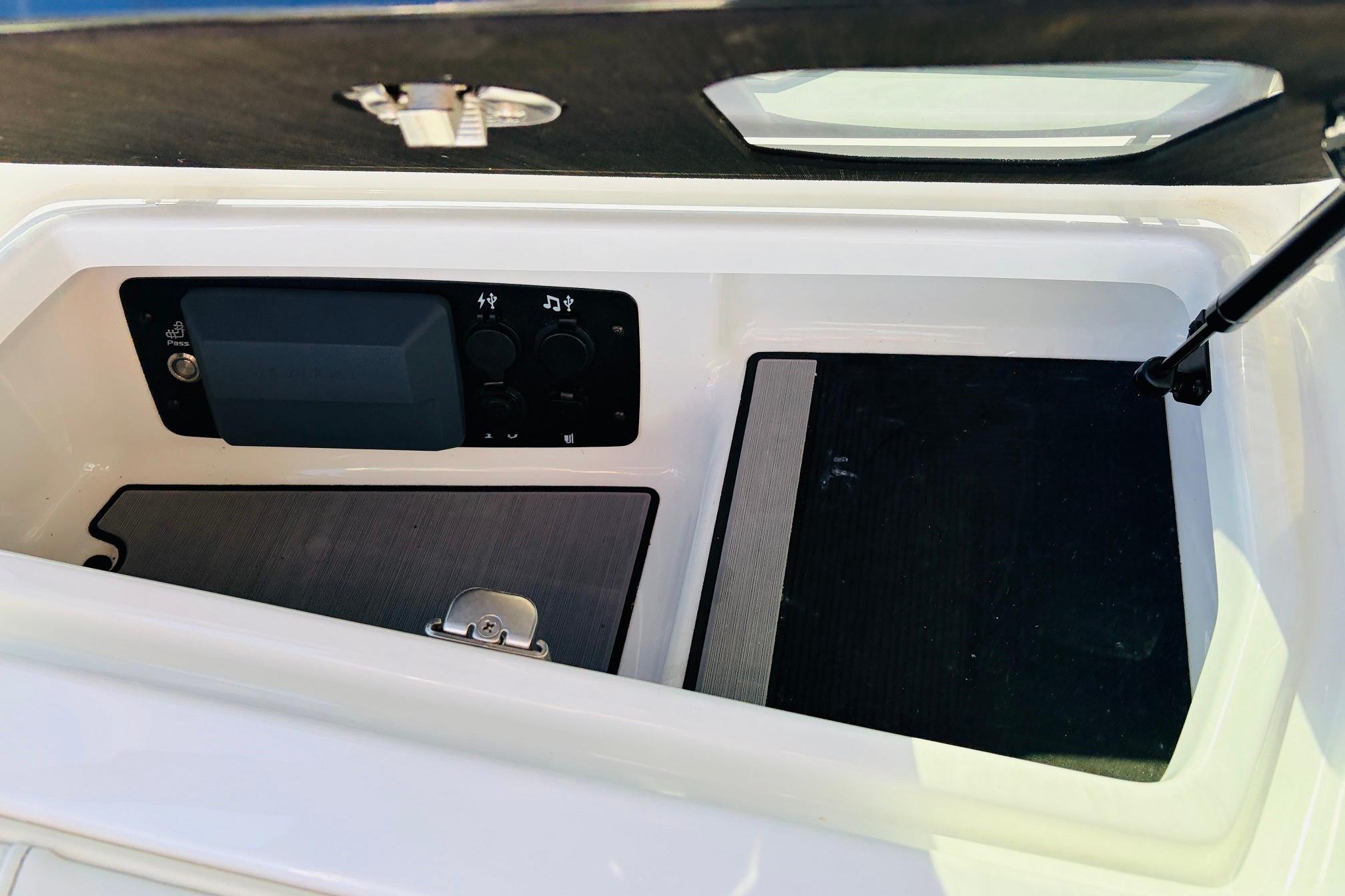 2023 Nautique Super Air Nautique G25 storage compartment with control panel and latch.