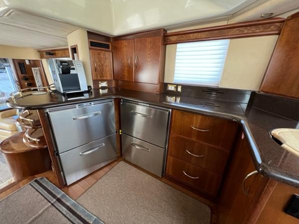 Modern kitchen in a 2009 Ovation 52 yacht with stainless steel appliances.