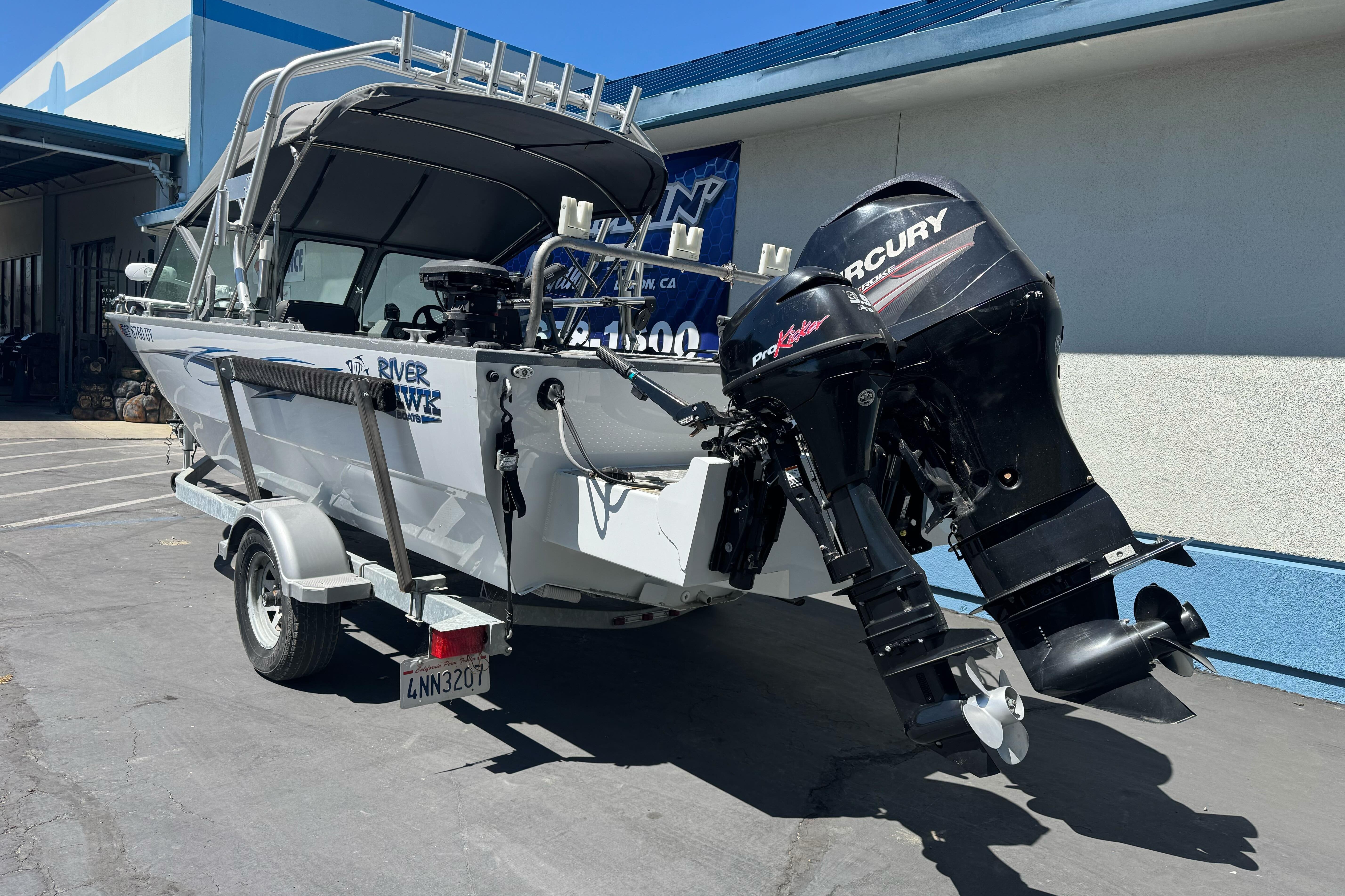 2014 River Hawk 19 GB boat with Mercury outboard motor on a trailer.