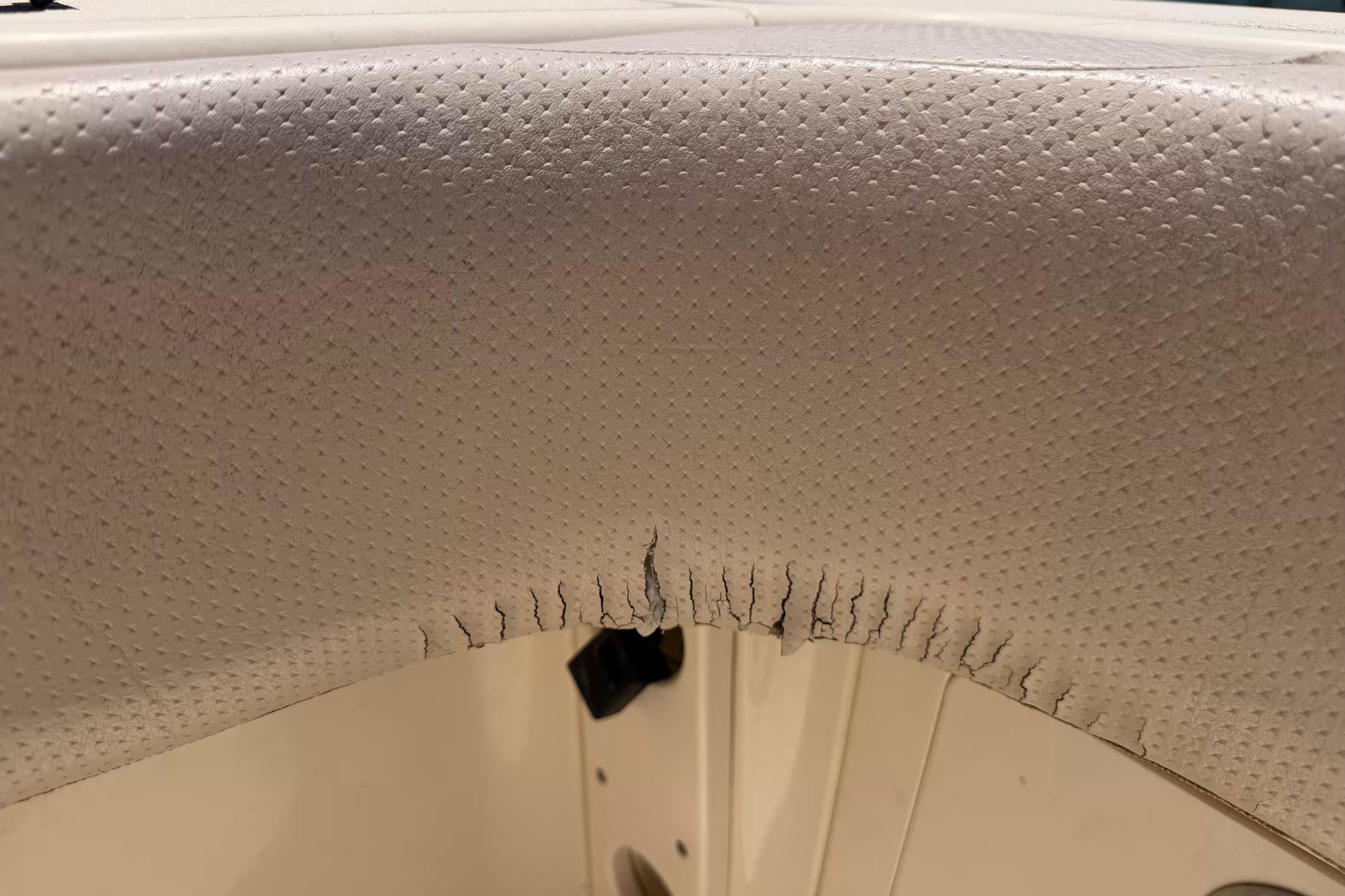 Torn upholstery on a 2007 Scout 262 Abaco boat seat.