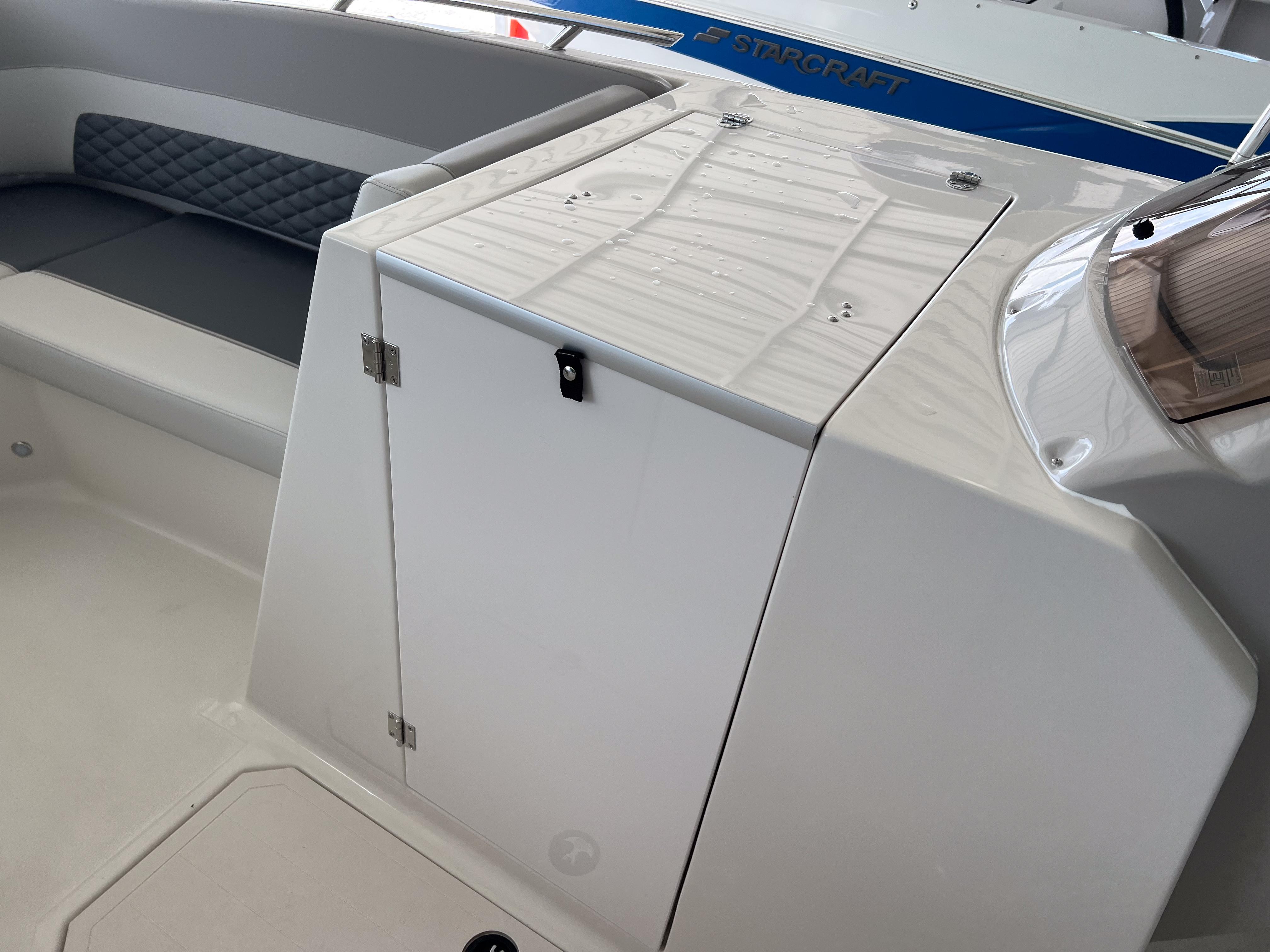 2026 Starcraft SVX 231 OB boat interior with seating and storage compartment.