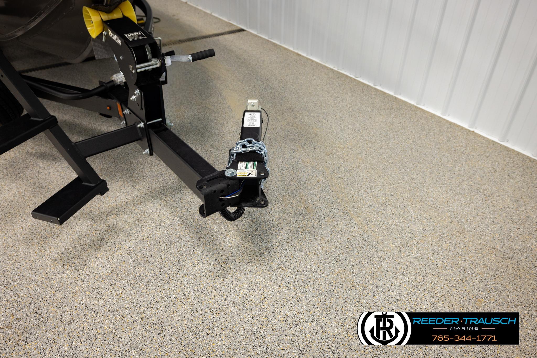 Trailer hitch of a 2026 Lund 1975 Tyee boat in a showroom.