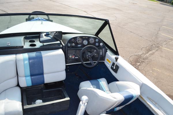 1989 Correct Craft Ski Nautique boat interior with blue and white seating and dashboard controls.
