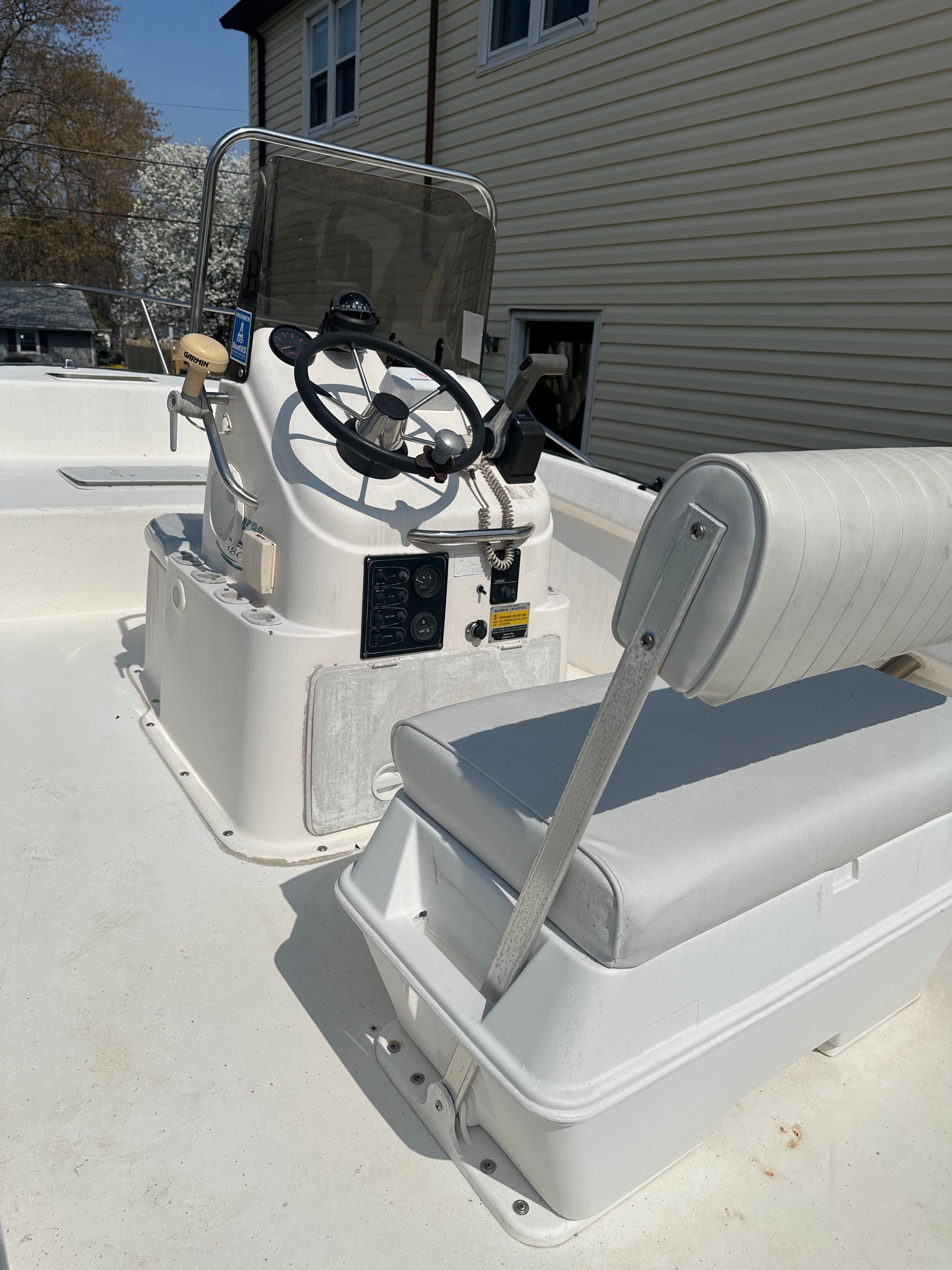 A 2003 Key Largo 180 Center Console boat with a white helm and bench seat.