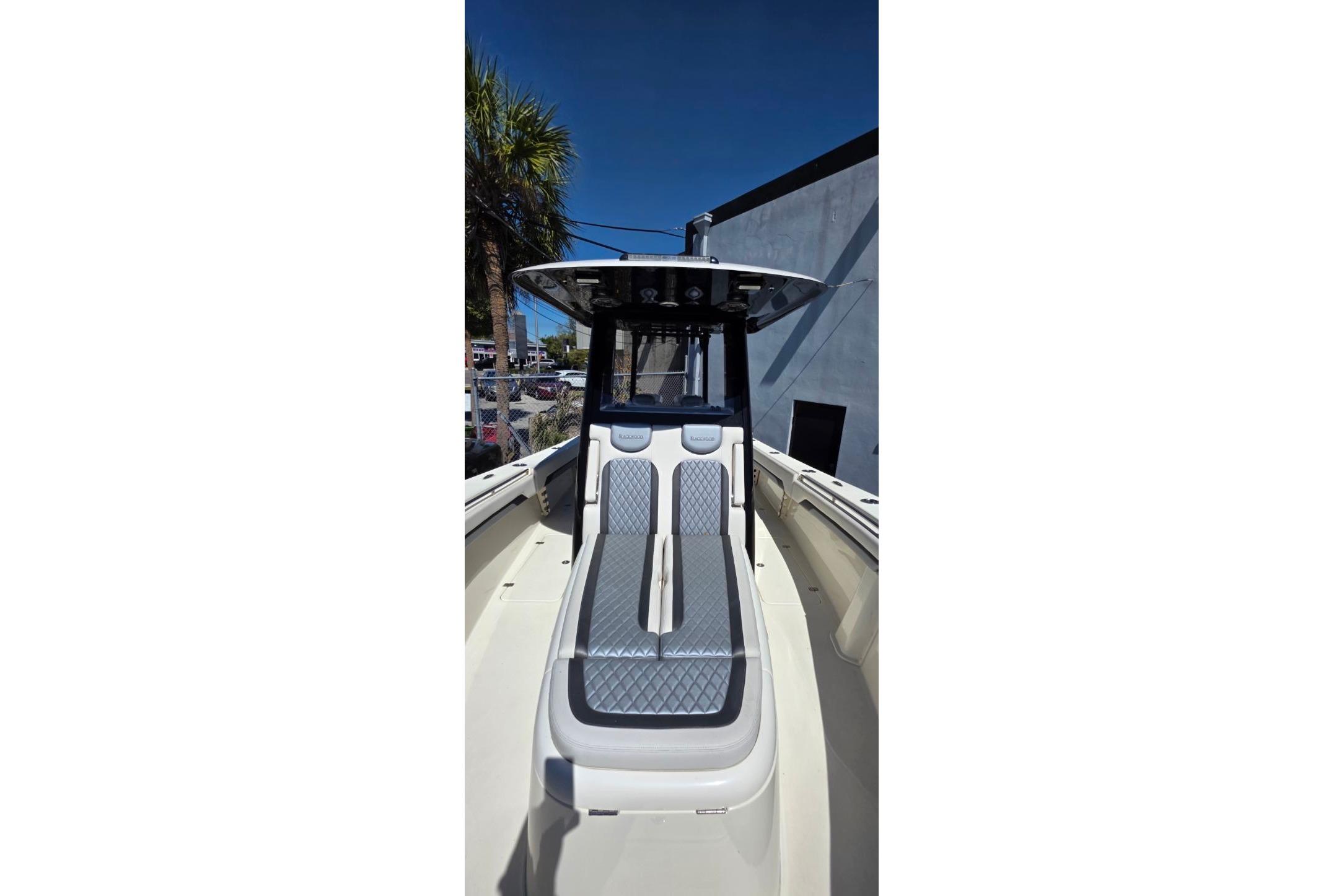 2024 Blackwood 290 boat with sleek seating and modern design under clear blue sky.