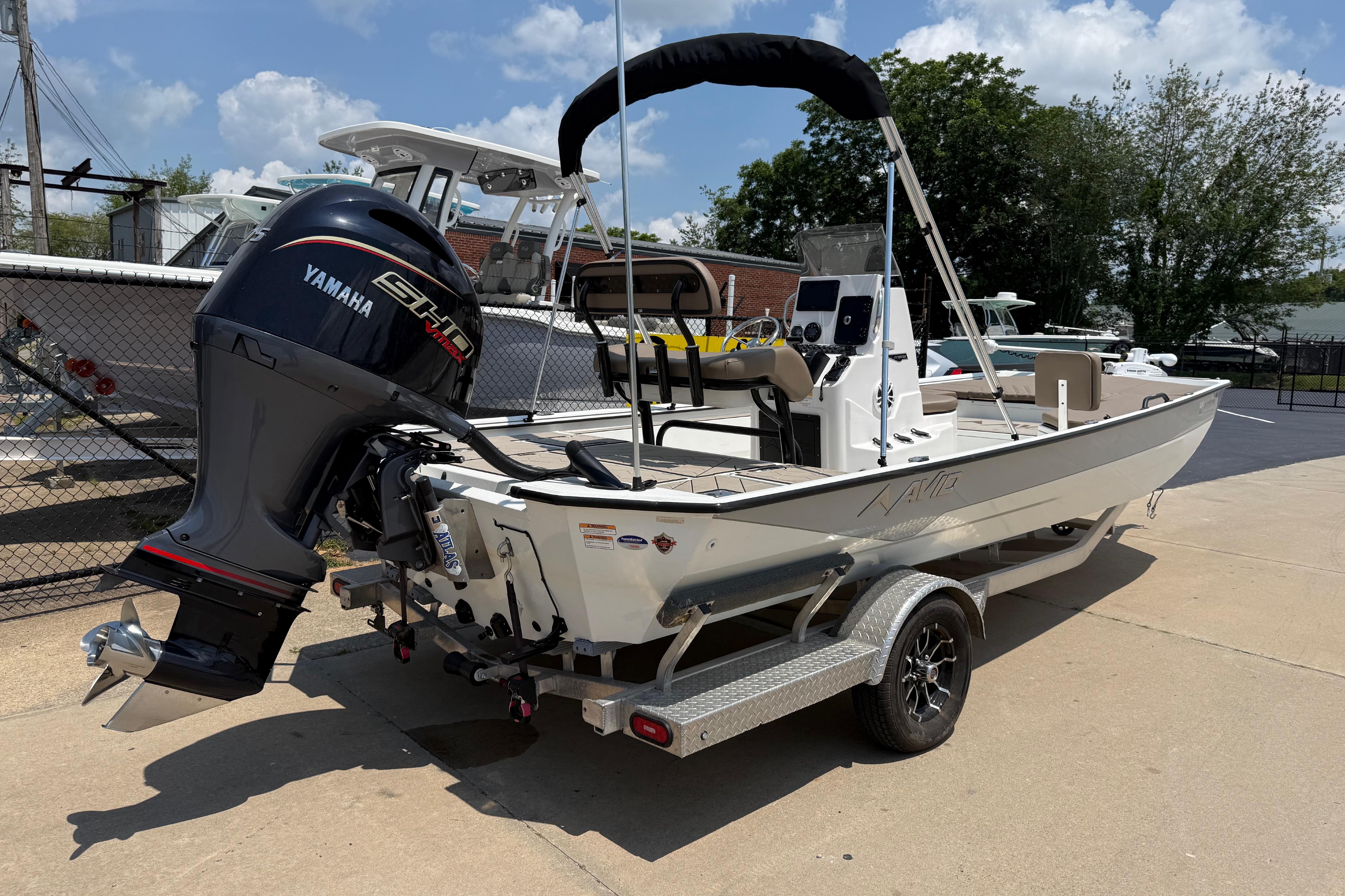 2025 Avid 22 Recon boat with Yamaha engine on trailer, parked outdoors.