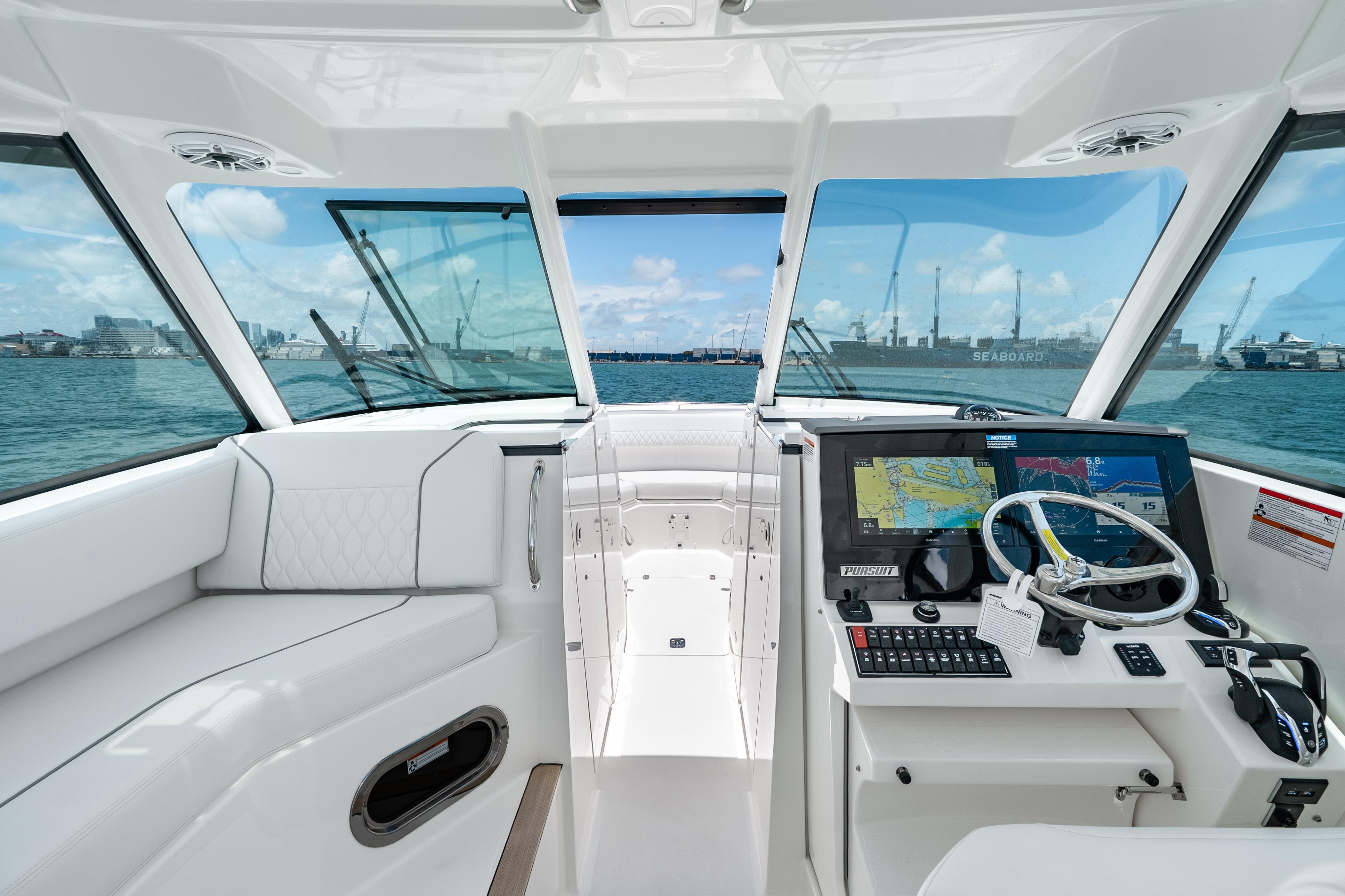 2026 Pursuit DC 326 Dual Console boat interior with navigation system and ocean view.