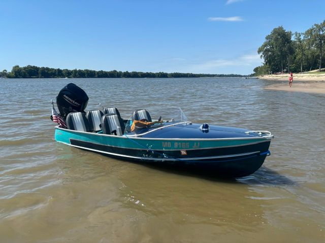 1958 Richline Knight Deluxe boat on calm water.