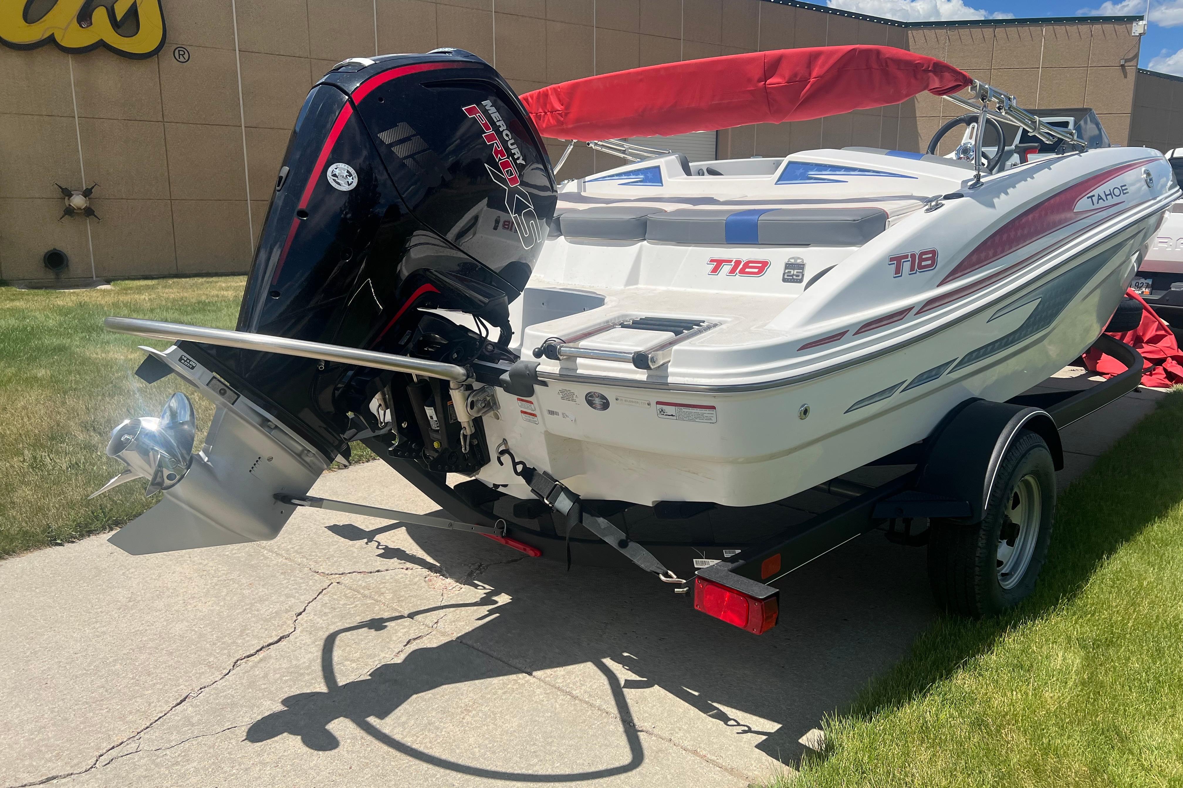 2023 Tahoe T18 boat with Mercury Pro XS engine on a trailer, outdoors.