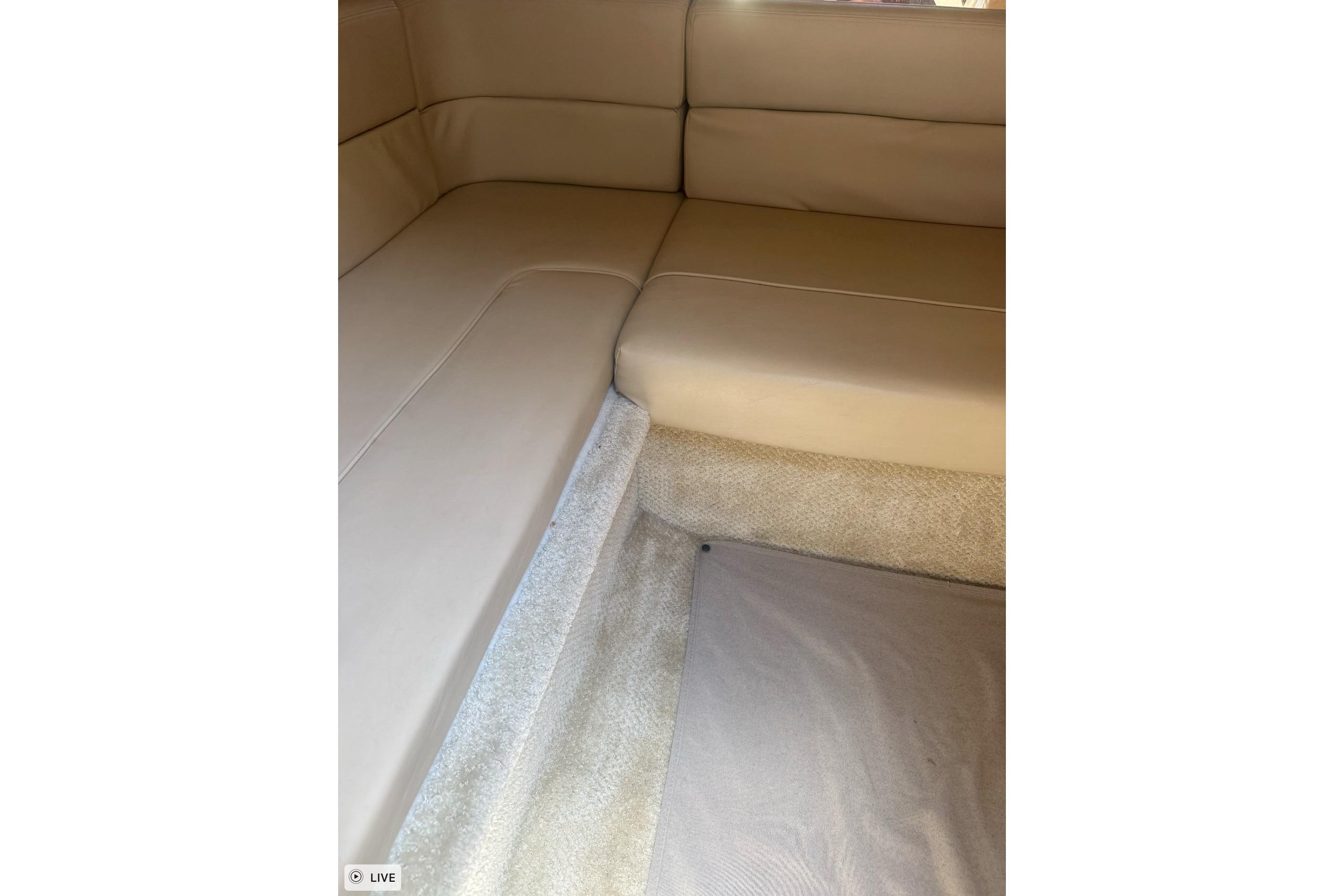 Interior seating of 2006 Sea Ray 300 Sundancer with beige upholstery and carpeted flooring.